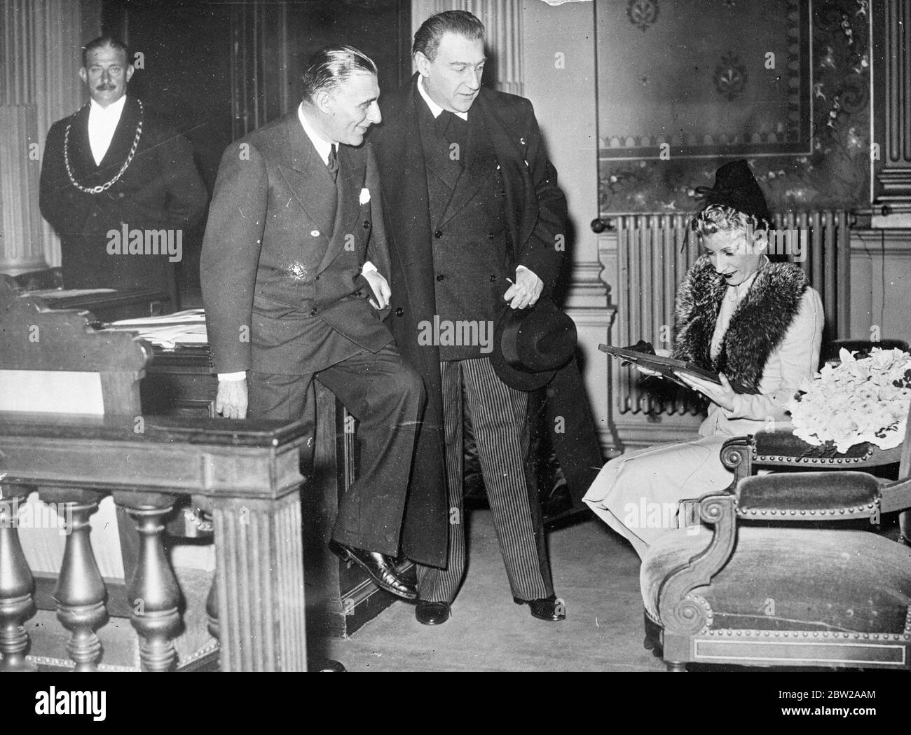 With the blessings of Sasha Guitry!. M Sacha Guitry, the famous French playwright, was a guest at the wedding of Mlle Mireille, noted French actress, to M Emmanuelle Berl. Photo shows, M Sasha Guity (centre) , talking with the bride and bridegroom at the Mairie. 27 October 1937 Stock Photo