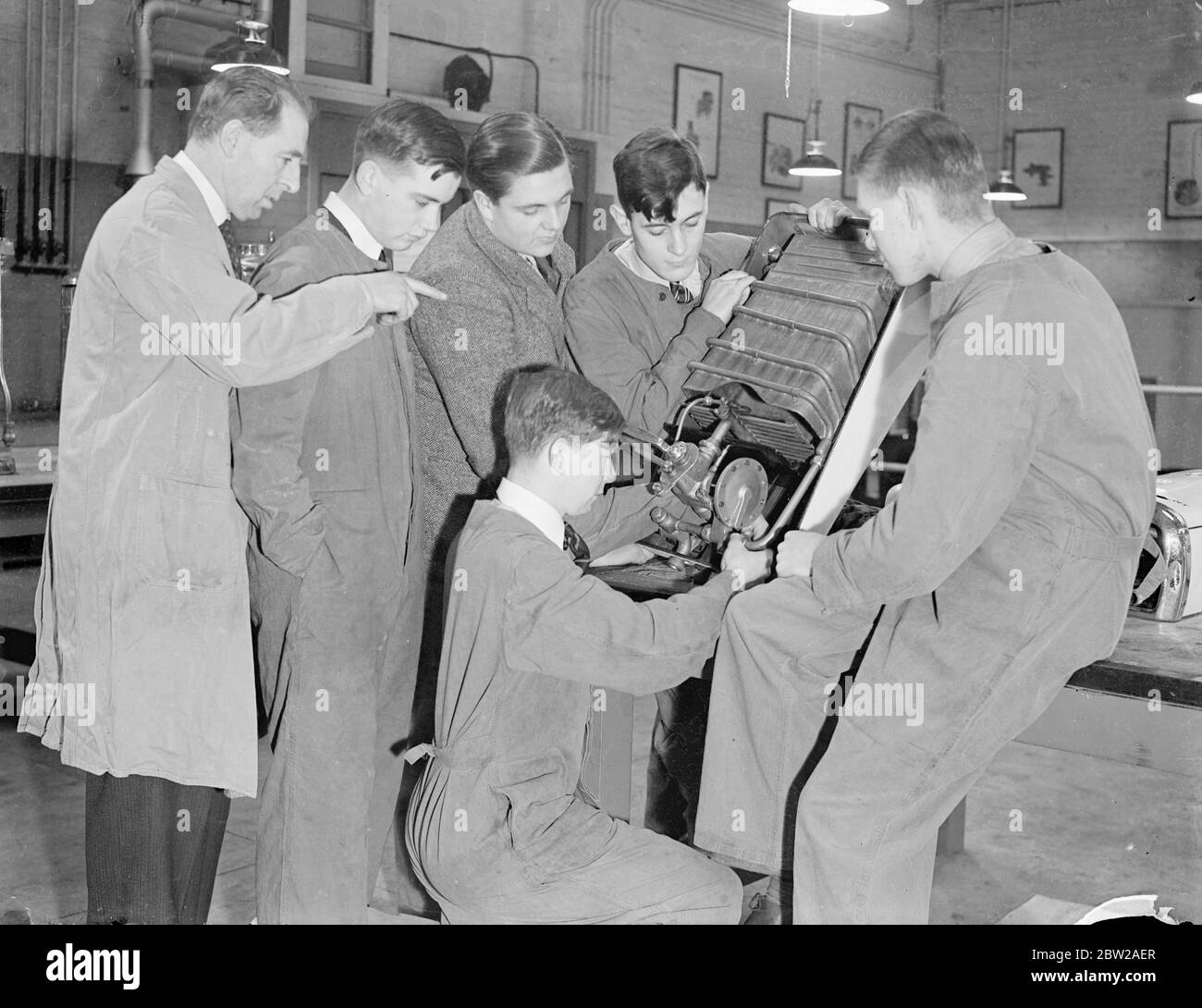 Public schoolboys learn to be gas fitters in London. Boys from famous public schools and the universities are fixing gas meters and gas fires in the homes and shops of 8 million users throughout London and from Windsor to Southend. The boys are trained at Watson House, Fulham, which is the gas equivalent to Hendon training college for young police officers. At present boys from Magdalen College School, Oxford, Shrewsbury, Christ Hospital, Haileybury and Merchant Taylors School are receiving training as Gassman. It is considered that the contact between gas employees and the public has now so m Stock Photo