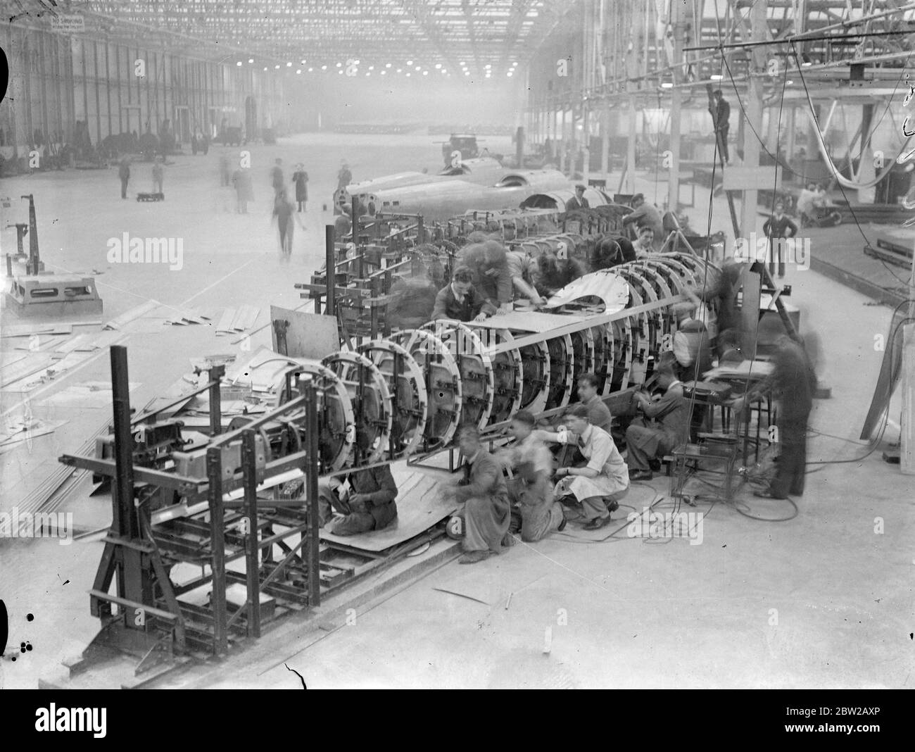 'Shadow factories'silent allies of Britain's Air Force. This series of pictures is the first ever made in Britain's 'shadow factories'the centres organised among motor manufacturers throughout the country to aid the Royal Air Force expansion scheme. Less than a year ago the 'shadow factories'were only an idea, but now high-speed work has established buildings on Marstons and given a valuable ally to the aircraft industry. Photo shows, assembling the fuser larges of the first planes produced at the Austin 'shadow'factory at Birmingham. Only a year ago, Marston covered the site of this factory.. Stock Photo