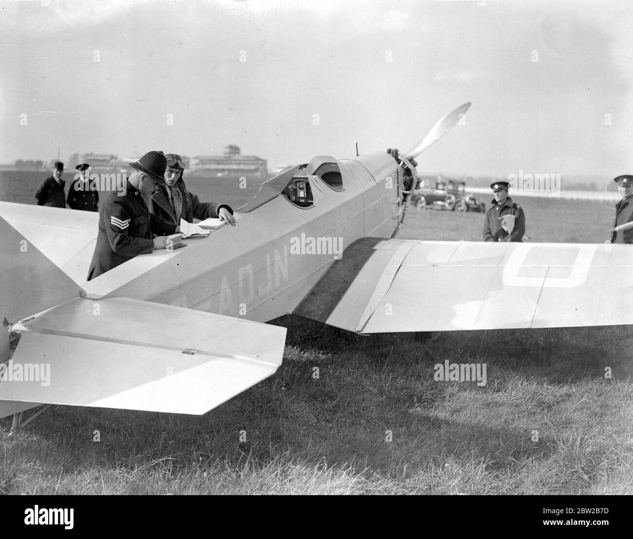 Inspecting the papers of a pilot who landed on the course at Newbury Races , contrary to regulations . 25 October 1935 Stock Photo