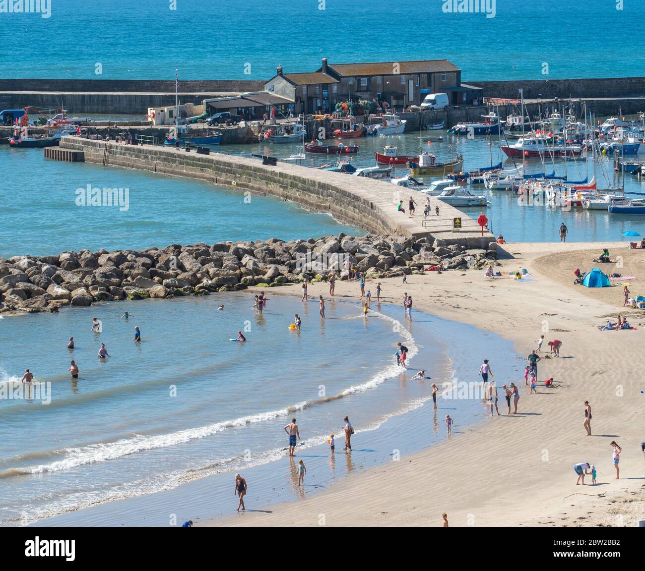 Lyme Regis, Dorset, UK. 29th May, 2020. UK Weather. Scorching hot sunshine and clear blue skies at the seaside resort of Lyme Regis on the hottest day of the year so far. Families and beachgoers are expected to flock to the beach to enjoy socially-distanced sunbathing as the heatwave continues into the weekend. Credit: Celia McMahon/Alamy Live News Stock Photo
