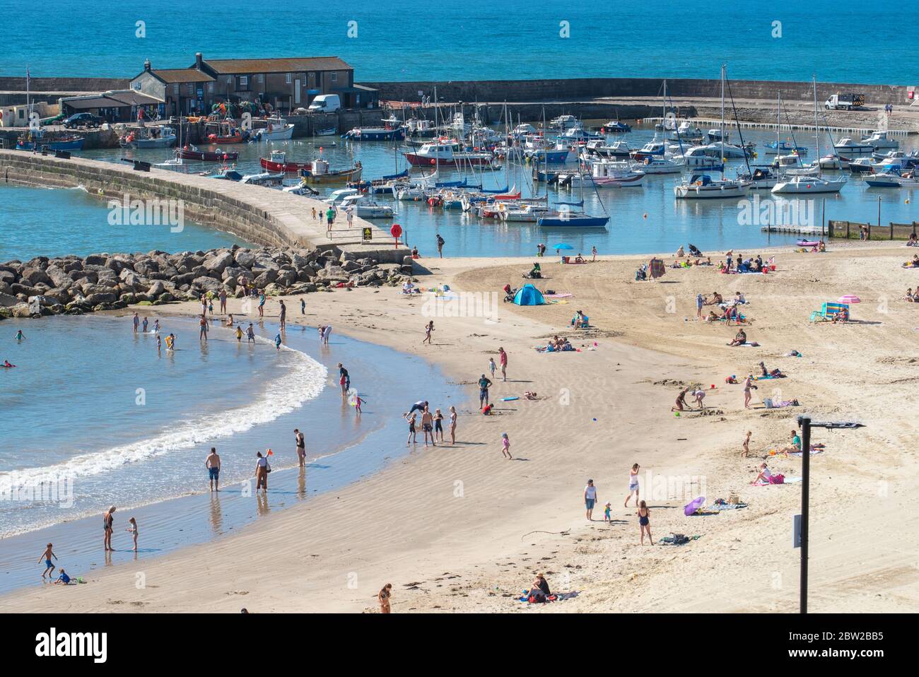 Lyme Regis, Dorset, UK. 29th May, 2020. UK Weather. Scorching hot sunshine and clear blue skies at the seaside resort of Lyme Regis on the hottest day of the year so far. Families and beachgoers are expected to flock to the beach to enjoy socially-distanced sunbathing as the heatwave continues into the weekend. Credit: Celia McMahon/Alamy Live News Stock Photo