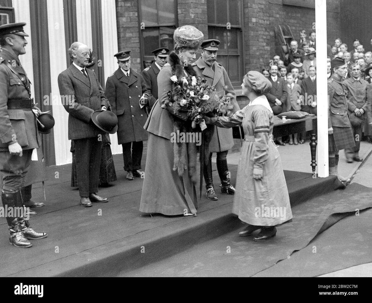 Royal Visit to Lincoln. Queen recieving a bouquet from a Munition Girl. (Messrs Robey and Co) 9 April 1918. Stock Photo