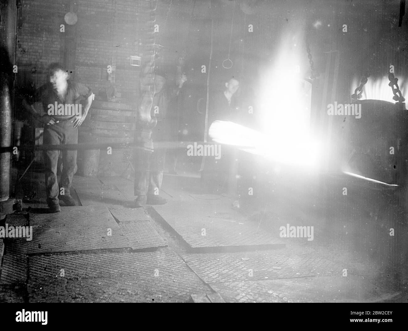 Where Britain forges victory. This pictures were taken in a Royal Ordinance factory of the Ministry of Supply where, thousands of workers are producing arms and ammunition which will help to ensure the victory of Britain and her Allies. Photo shows: Sparks fly from a converter (steelmaking furnace). 13 November 1939 Stock Photo