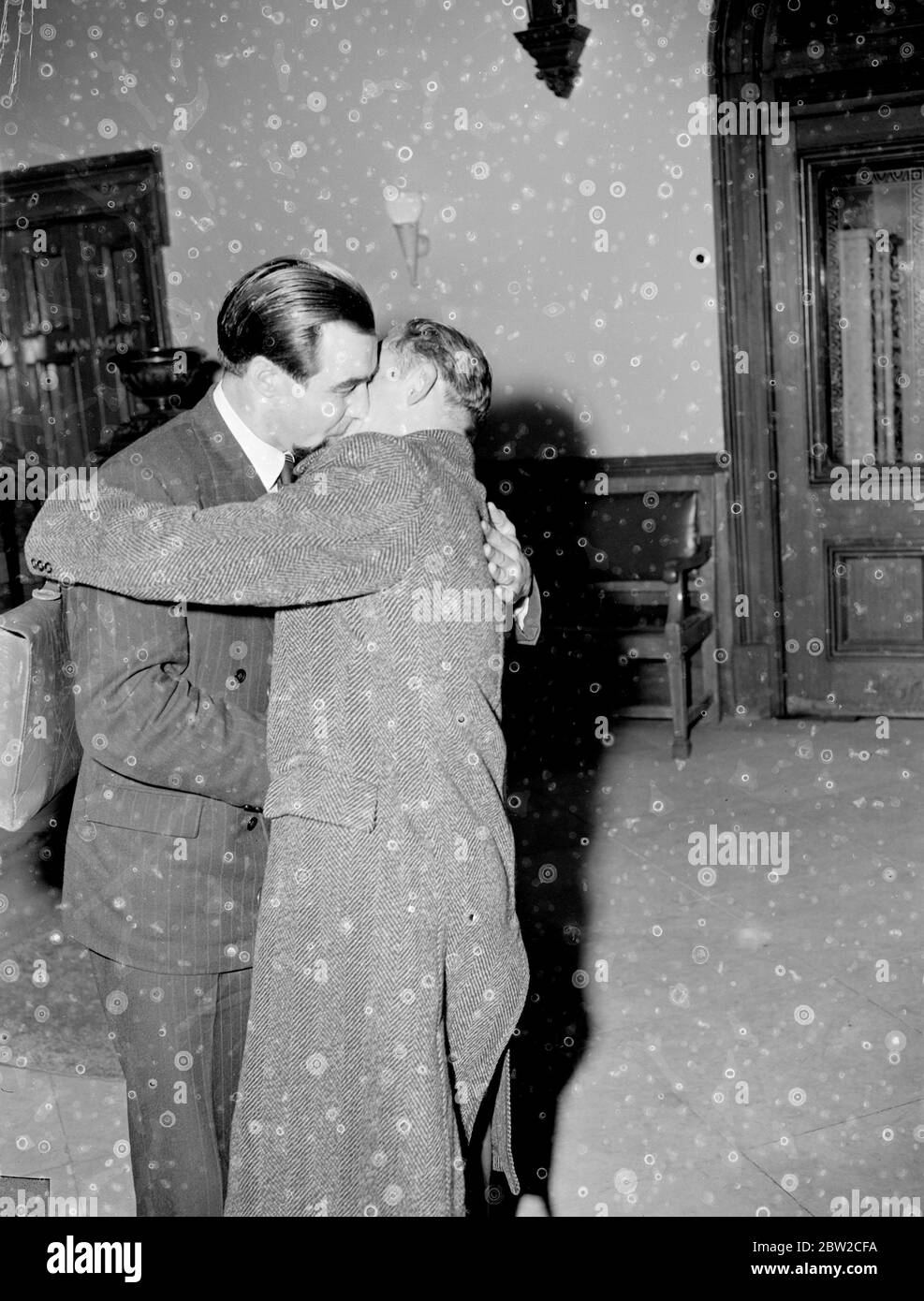 Red Army refugees embrace. Three Red Army men, two officers and a Corporal, tonight told of serving conditions in the Red Army to a gathering at the Caxton Hall, London, arranged by the British Free Russian Movement. They have all escaped from behind the Iron Curtain during the past 12 months. Corporal Andrei Novzhitsky (23) flew into London tonight from Berlin. He was formerly a member of a Soviet Guards Regiment. Brigadier R. C. Firebrace, former British Military AttachÃ© in Moscow, presided over the meeting. Photo shows two of the former Red Army men embrace on meeting at Caxton Hall tonigh Stock Photo