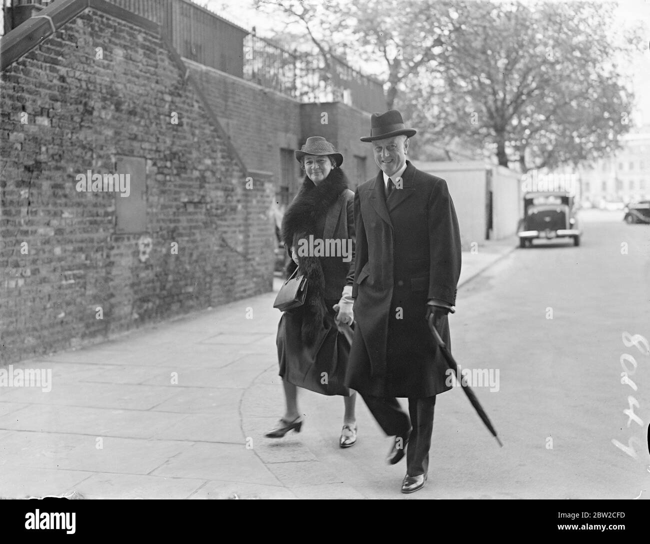 An important meeting of the Cabinet took place at No. 10 Downing Street, when the defence program and the situation in Palestine were among the subjects discussed. Photo shows : Sir Samuel Hoare, the Home Secretary, with his wife, Lady Maud Hoare, when he arrived for the Cabinet meeting . 19 October 1938 Stock Photo