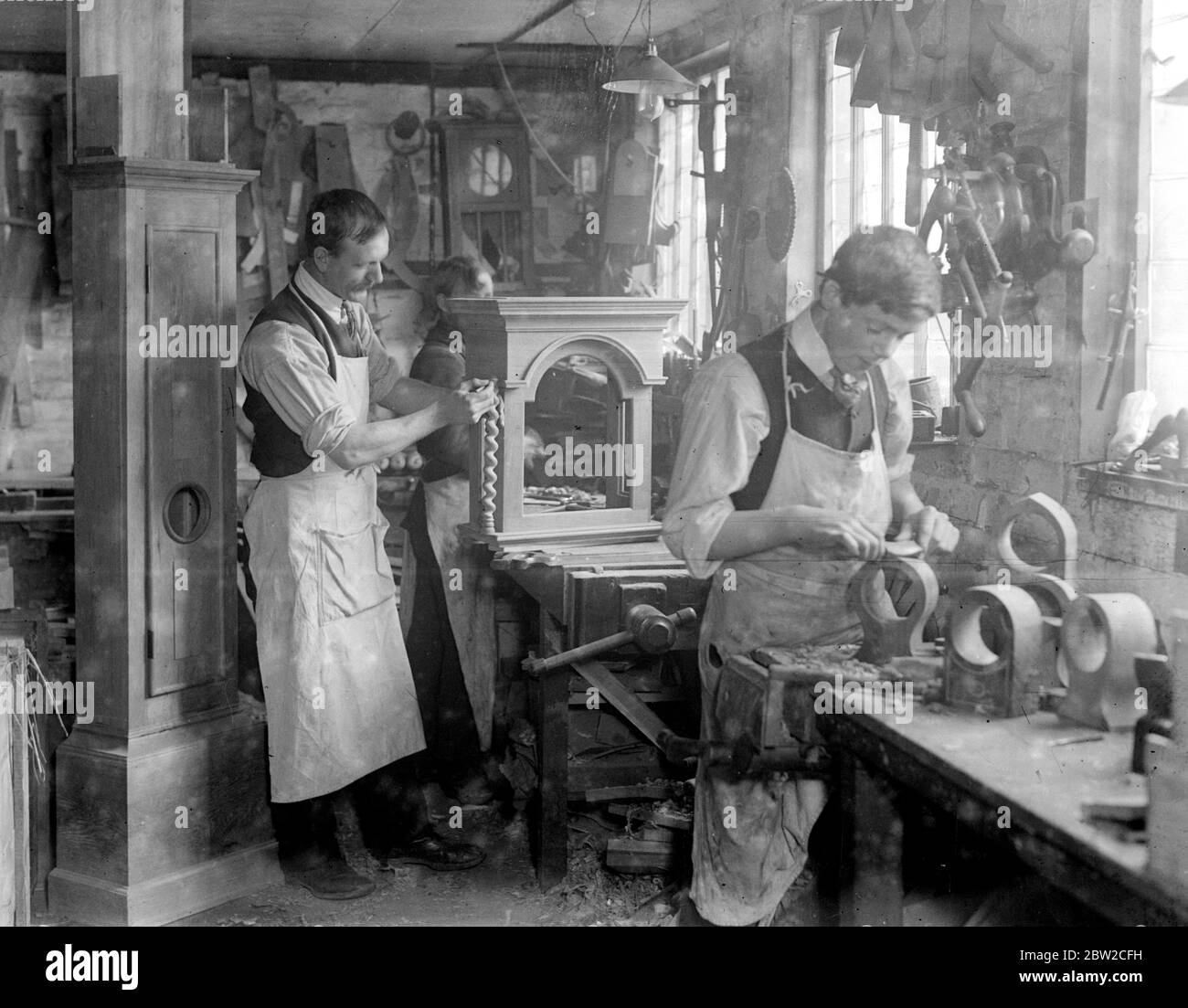 Messrs Stanton and Hill , a firm of cabinet makers at High Wycombe , is the only English firm making wooden clock cases , a trade which has been exclusively in the hands of the Germans and Austrians . Their first order for a thousand cases is now being executed. Photo shows ; Making the case for a ' Grandfather clock'. Stock Photo