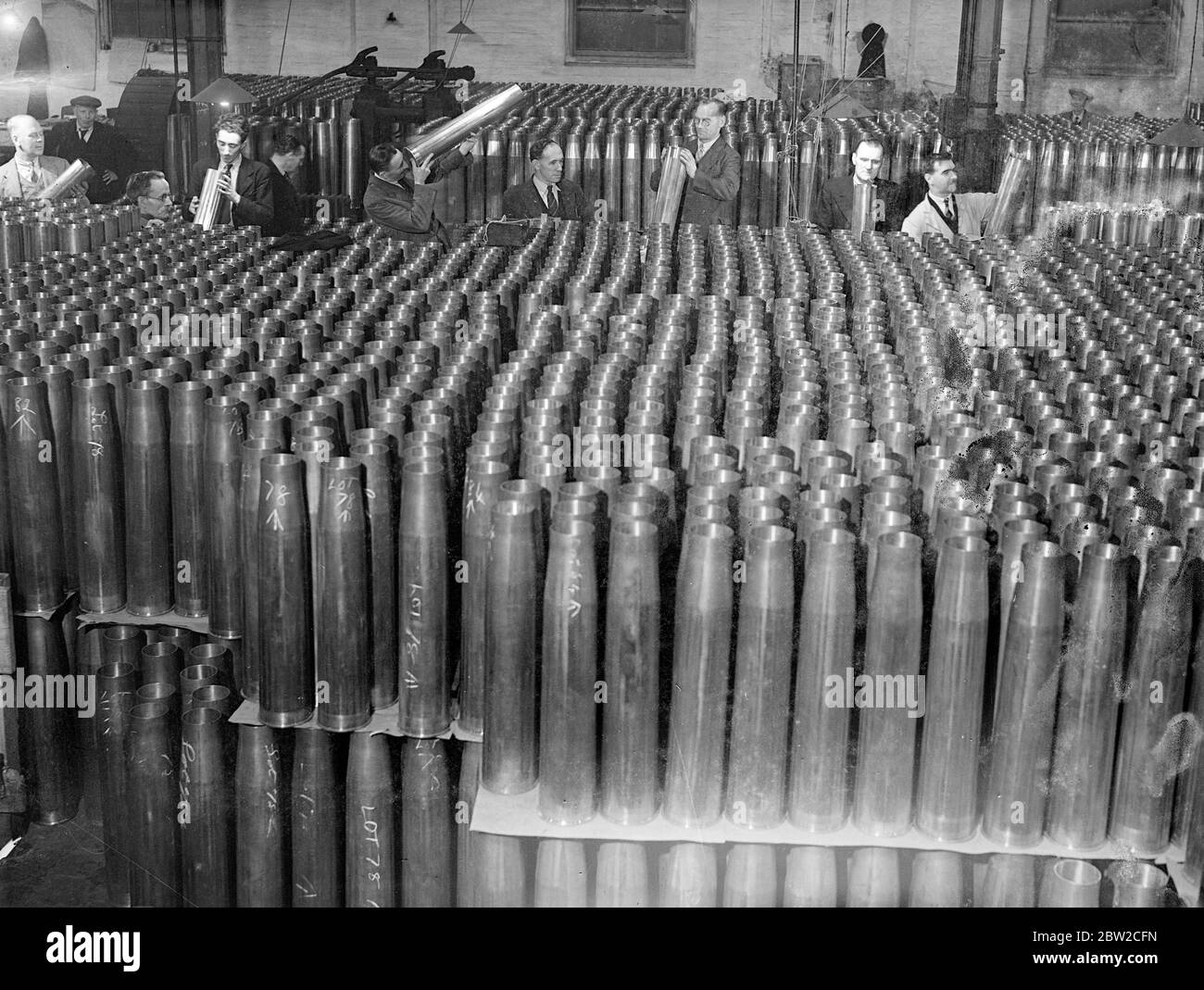 Where Britain forges victory. This pictures were taken in a Royal Ordinance factory of the Ministry of Supply where, thousands of workers are producing arms and ammunition which will help to ensure the victory of Britain and her Allies. Photo shows: inspecting a great mass of anti-aircraft cartridge cases. 13 November 1939 Stock Photo