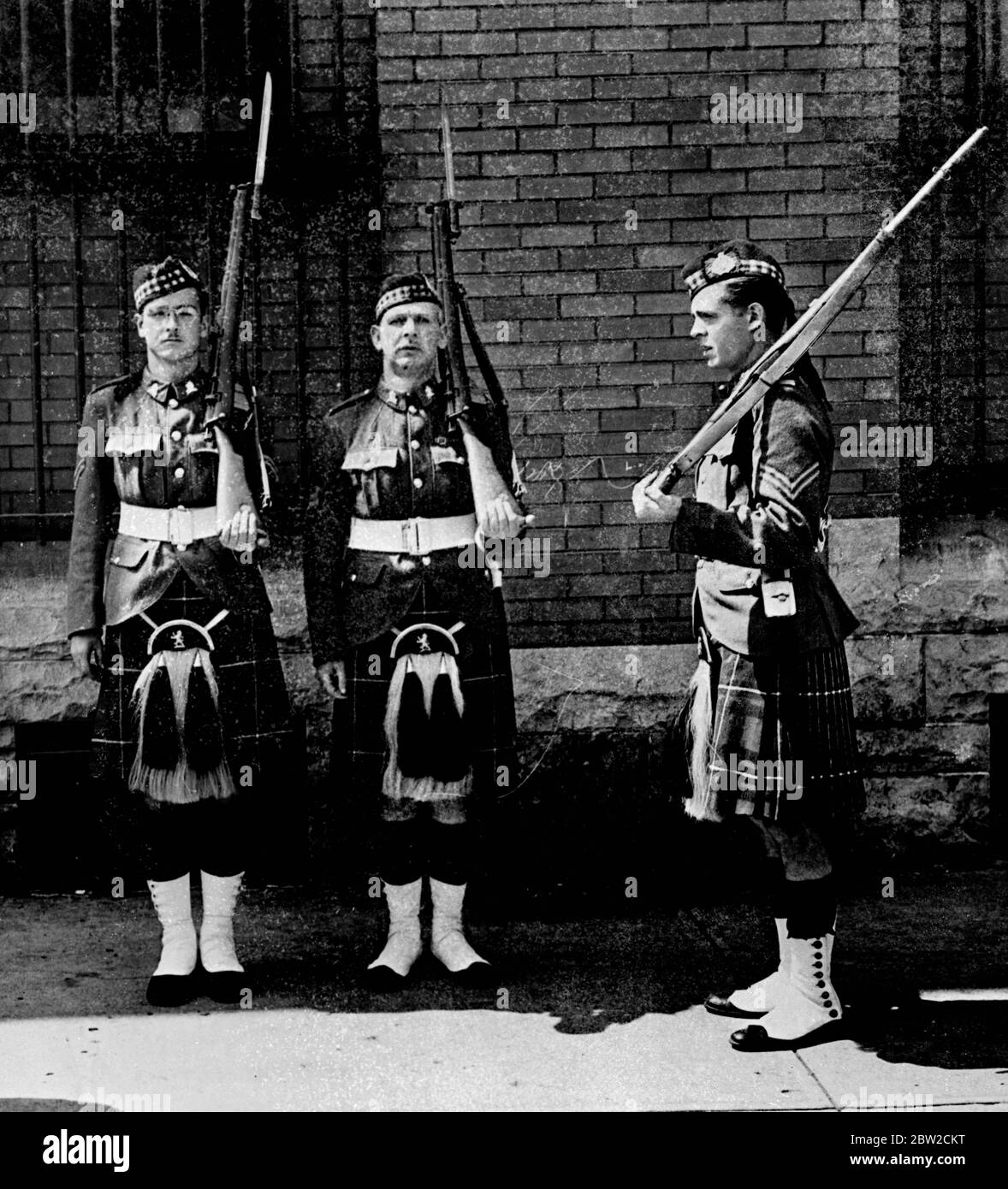 Canadian troops on constant guard in face of war scare Windsor, Ontario, Canada. Signs of Britain's preparations for war are visible these days along the Canadian - United States boundary. Here a change of guard is taking place as two fresh sentries come on duty at the Windsor Essex Scottish Regiment armoury, which has been under constant guard since Friday. 28 August 1939 Stock Photo
