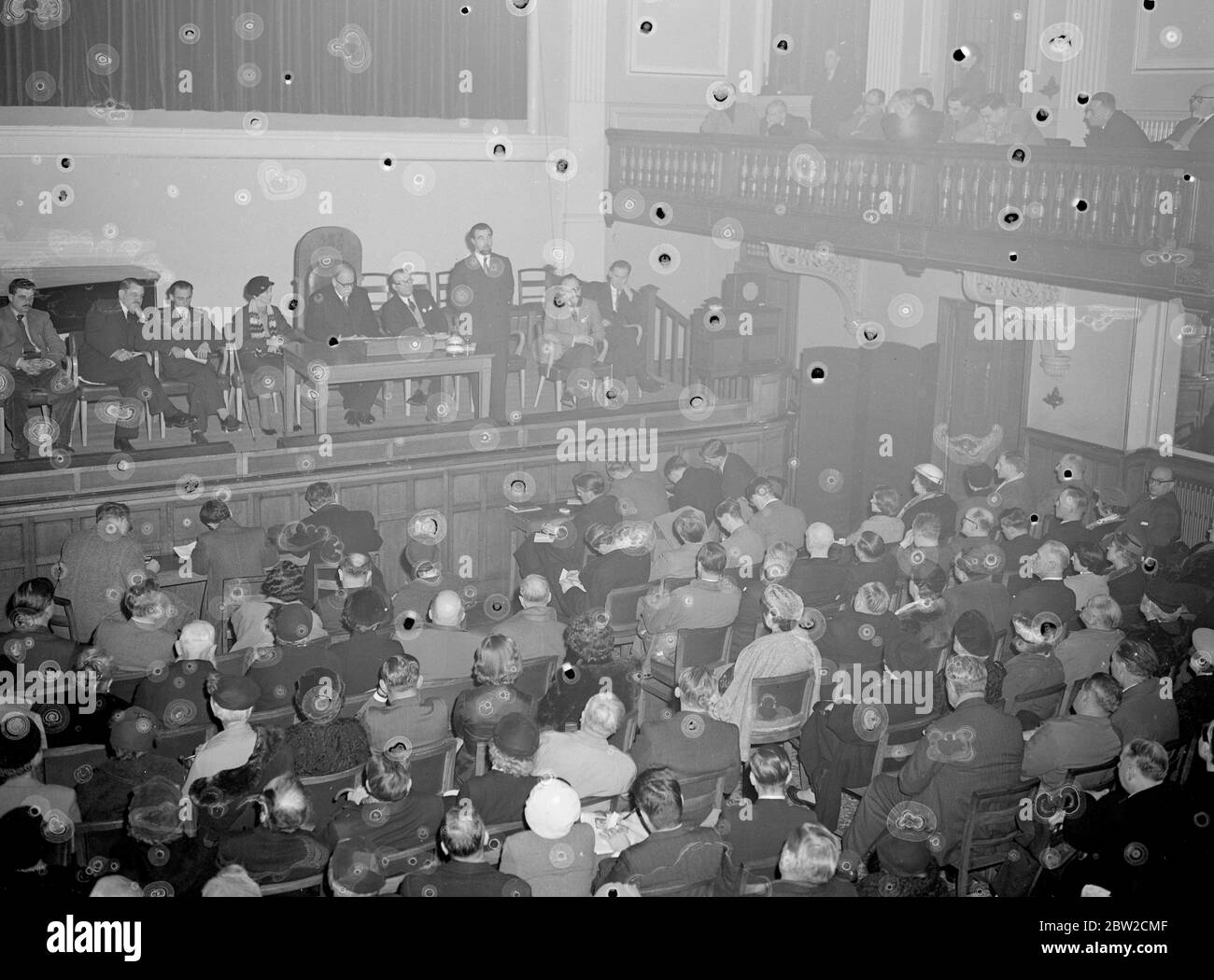 Three Red Army men, two officers and a Corporal, tonight told of serving conditions in the Red Army to a gathering at the Caxton Hall, London, arranged by the British Free Russian Movement. They have all escaped from behind the Iron Curtain during the past 12 months. 23-year-old Corporal Andrei Novzhitsky, flew into London tonight from Berlin. He was formerly a member of a Soviet Guards Regiment. Brigadier R. C. Firebrace, former British Military AttachÃ© in Moscow, presided over the meeting. Photo shows Senior Lieutenant Mikhail Tulin, 27, Russian Military Intelligence man addressing the meet Stock Photo