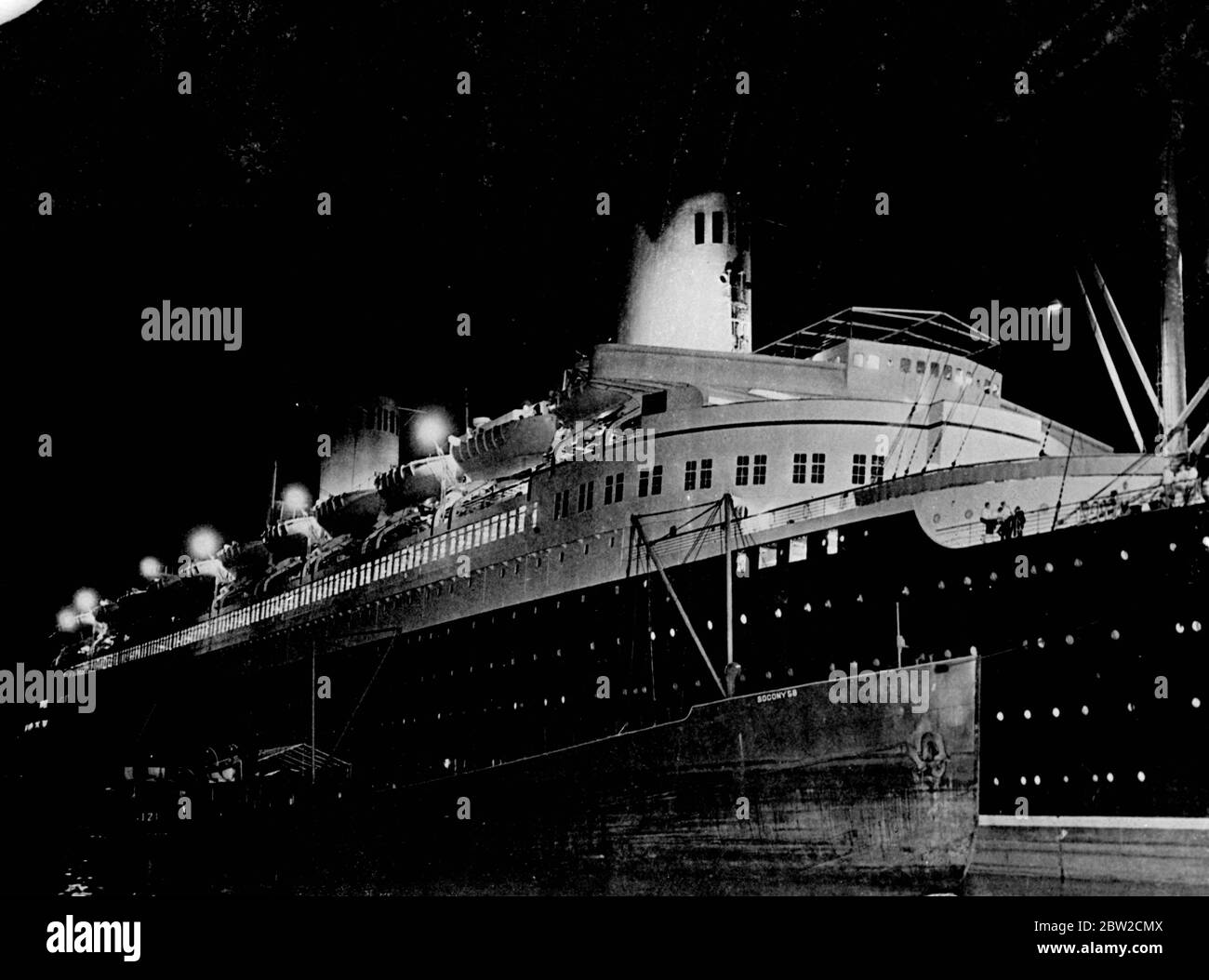 The North German Lloyd liner Bremen, which arrived in New York with 1600 passengers only a few hours before, is loaded with fuel oil from a tanker alongside during the early hours of 29 August, preparatory to dash back to Germany without passengers or cargo. Preparations for the trip home, under sealed orders and under the control of the Reich Navy were carried out in feverish haste and under close guard. 29 August 1939 Stock Photo