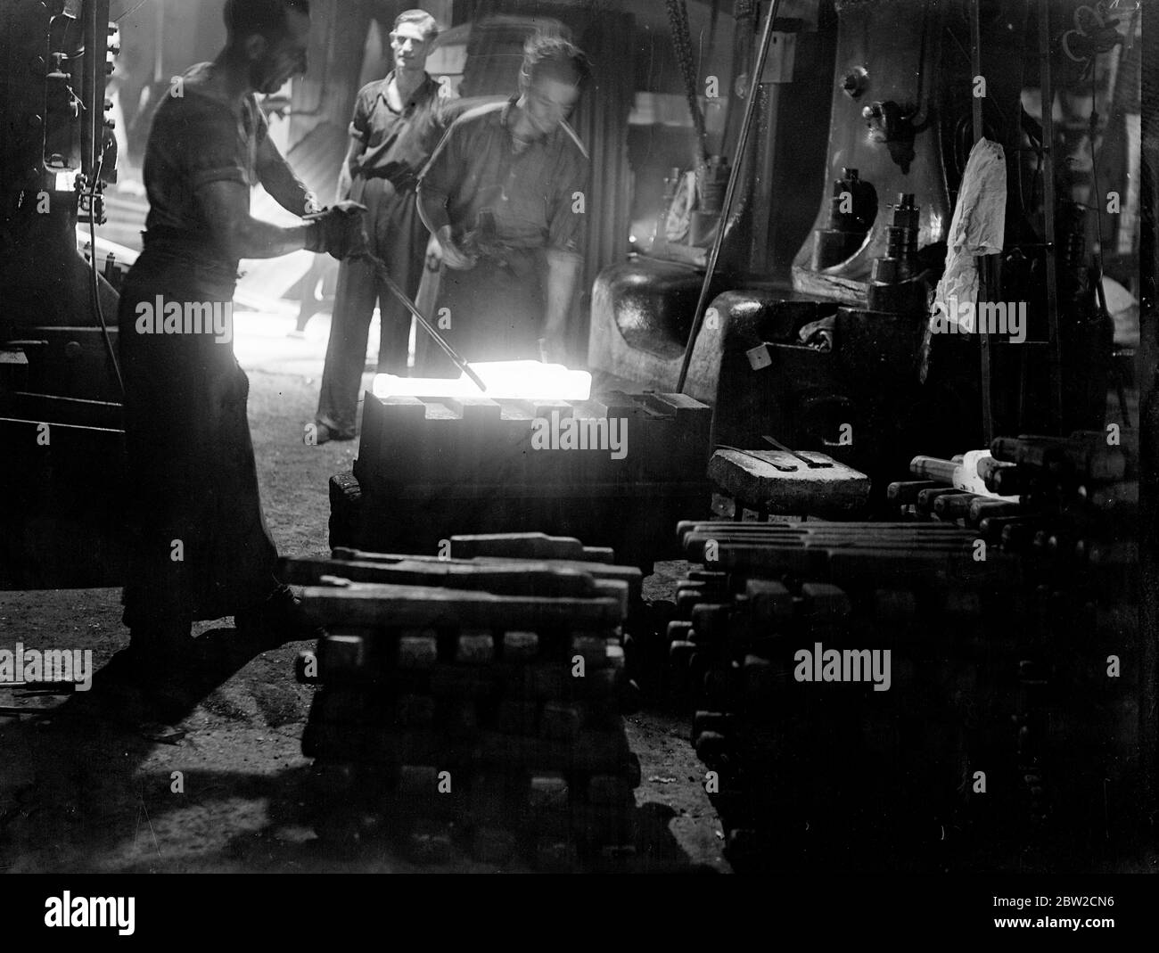 Turning out small arms by the thousand in a British factory. These pictures were made in a Royal Ordinance factory of the Ministry of Supply specialising in the production of small arms. Here, thousands of weapons such as machine guns, rifles and revolvers are being turned out at a high speed for the use of Britain's rapidly growing force. Photo shows forging a Bren gun. 15 November 1939 Stock Photo