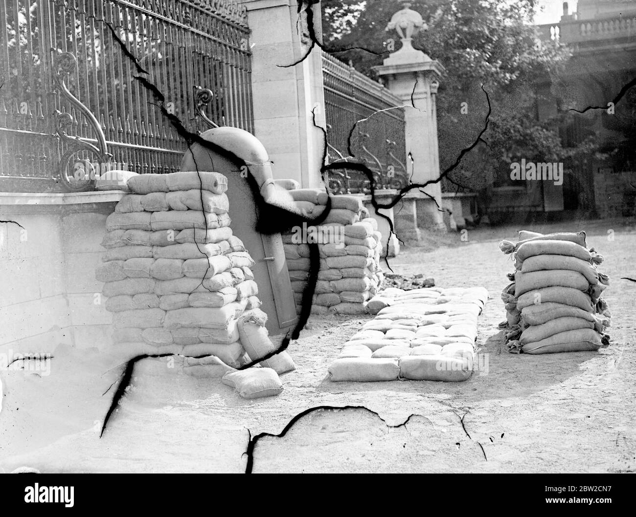 Air raid shelters are being constructed or placed in position at the Royal palaces in London. Special types of steel shelter - similar to those for the use of key men in air raids - have been placed in position for the sentries. A steel shelter for the sentry placed amid a pile of sandbags in Buckingham Palace courtyard. 29 August 1939 Stock Photo