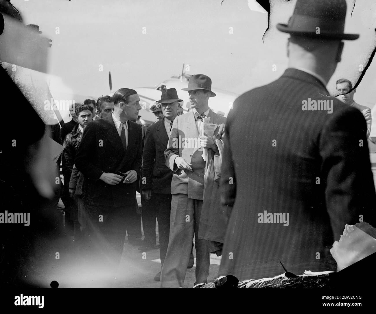 Carrying three men, Admiral Boyle, Sir Paul Dukes and Mr Harrison, the special plane used by British Ambassador to Berlin, Sir Neville Henderson, arrived at Heston Aerodrome from Berlin. Also aboard it was a luggage belonging to Sir G. Ogilvie Forbes, who is second in command to Sir Neville with the title of Minister. The Foreign Office stated that the three men have no connection with the Foreign Office. The men refused to give any information concerning themselves. 29 August 1939 Stock Photo