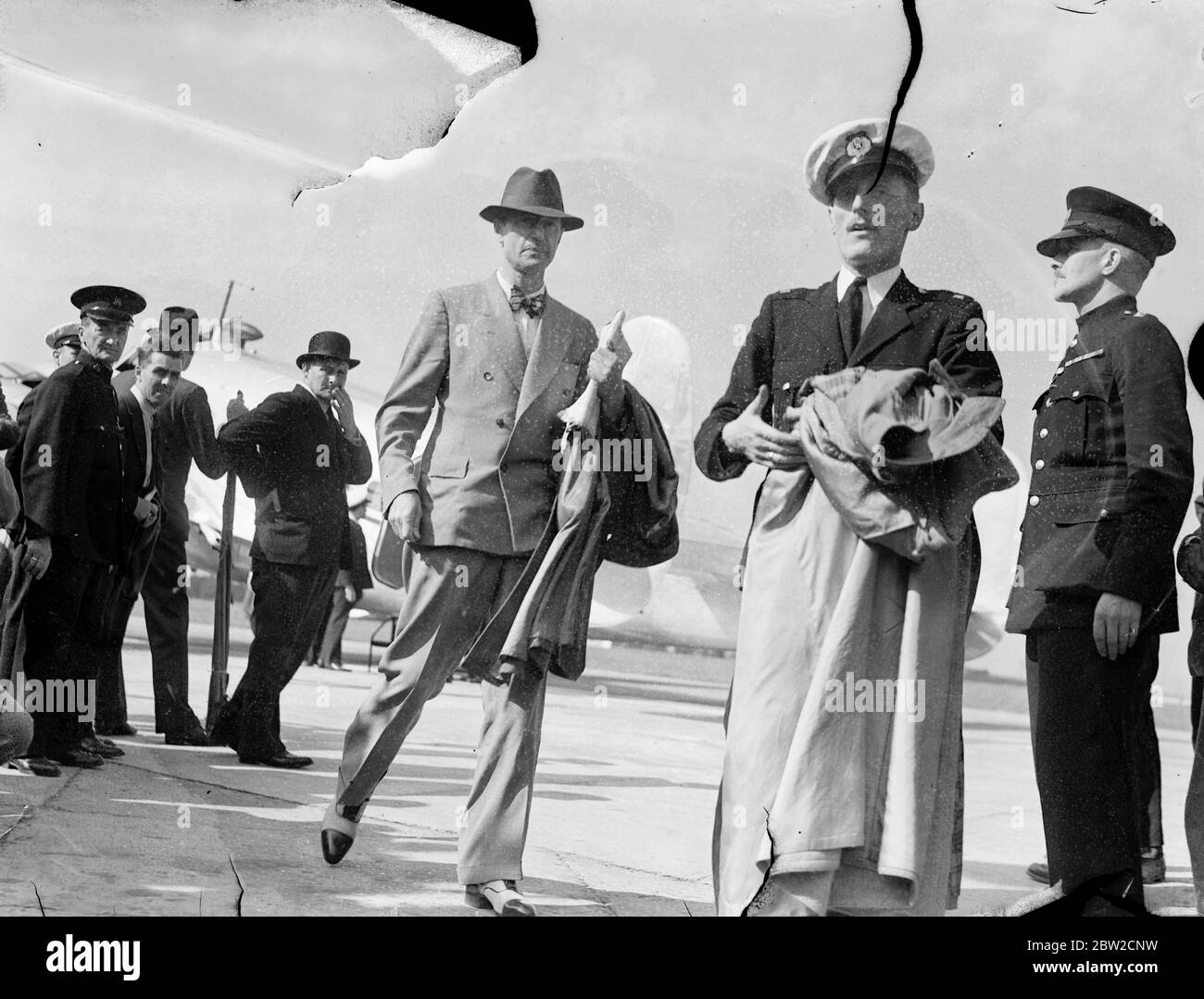 Carrying three men, Admiral Boyle, Sir Paul Dukes and Mr Harrison, the special plane used by British Ambassador to Berlin, Sir Neville Henderson, arrived at Heston Aerodrome from Berlin. Also aboard it was a luggage belonging to Sir G. Ogilvie Forbes, who is second in command to Sir Neville with the title of Minister. The Foreign Office stated that the three men have no connection with the Foreign Office. The men refused to give any information concerning themselves. 29 August 1939 Stock Photo