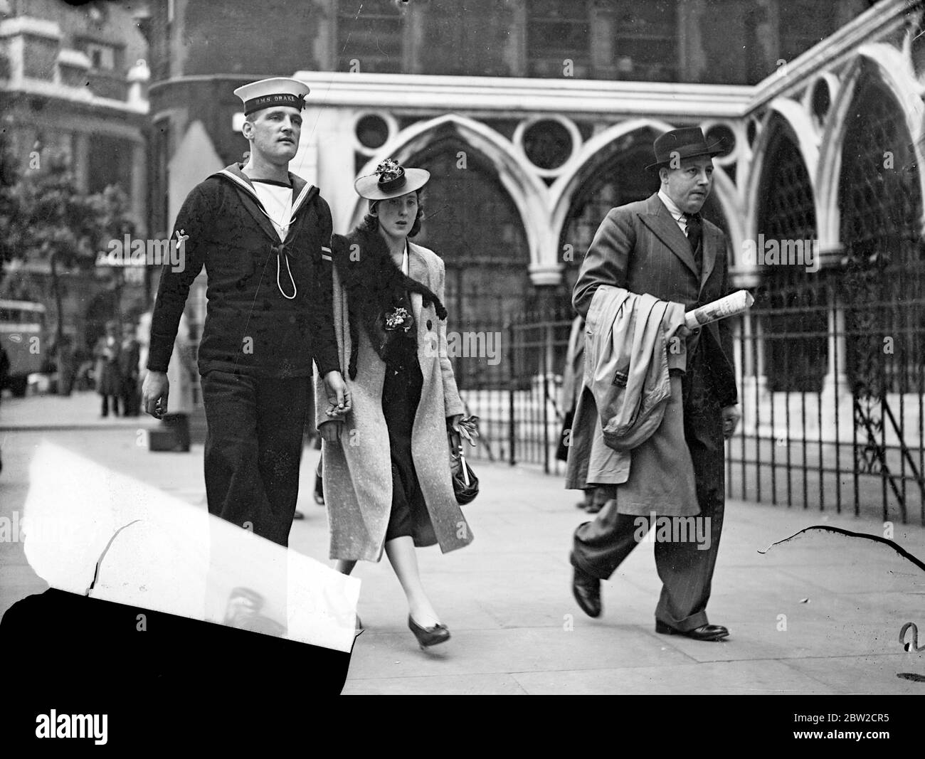 The inquiry into the loss of the submarine Thetis with 99 lives was continued before the tribunal presided over by Mr Justice Bucknill in the Admiralty Division. Photo shows Leading Stoker W. C. Arnold and Mr F. Shaw of Cammell Laird's, two of the four survivors arriving with Mrs Arnold for hearing today (Wednesday). 5 July 1939 Stock Photo