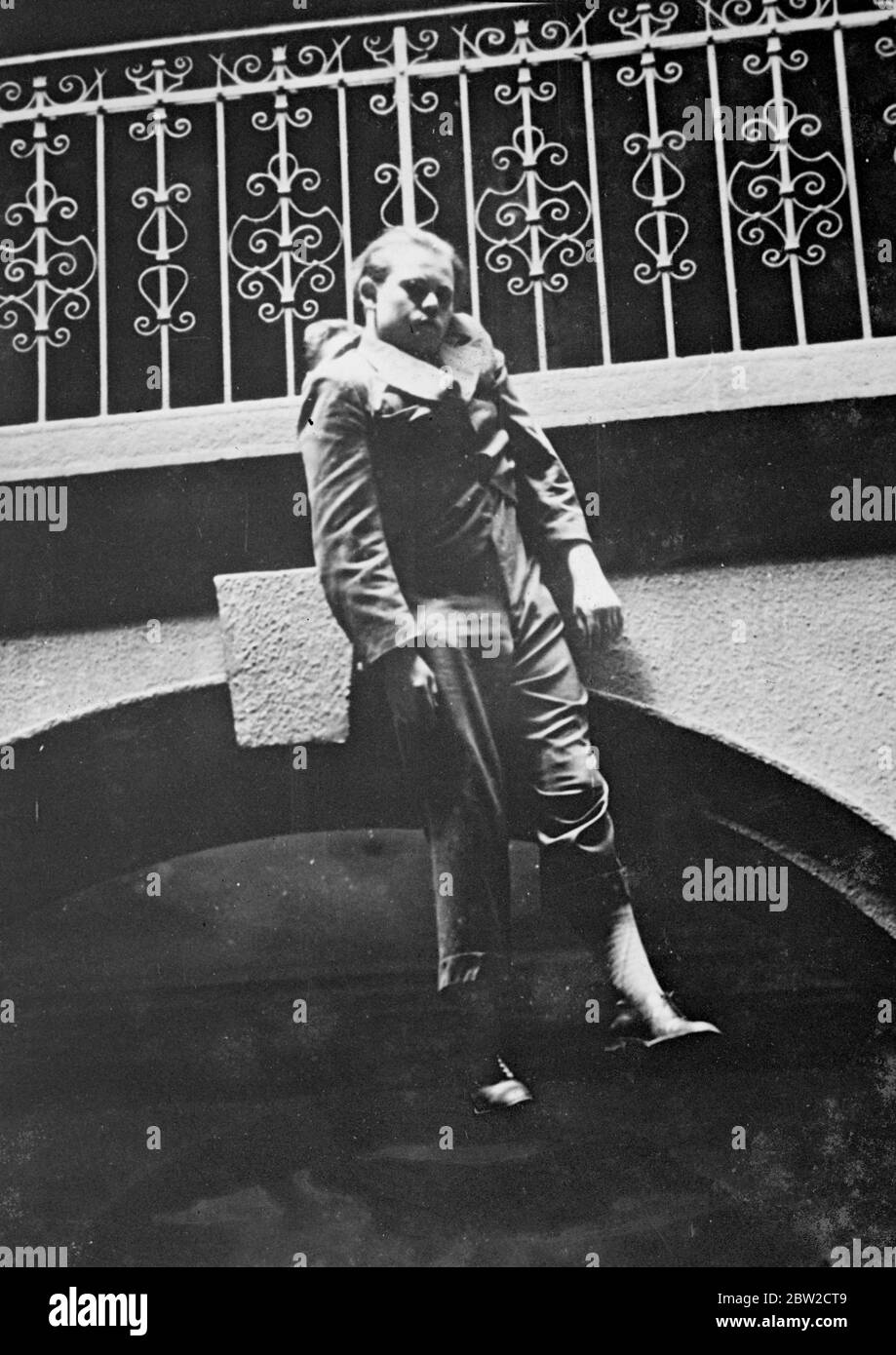 Zoltan Kovesy halted on his downward plunge by the hand of Lazlo Horvath. A moment later he was continuing his journey to the pavement beneath. The young composer tried to commit suicide by throwing himself from the third floor of the apartment house in which he lived in Budapest. Other tenants stood terrified and helpless as Kovesy pleaded with them not to prevent him taking his life, but one Lazzlo Horvath, a boxer's trainer, made a desperate grab at Kovesy's clothing as he left the balcony. Horvath was unable to hold on, however, and Kovesy plunged downwards. He was taken to hospital in a s Stock Photo