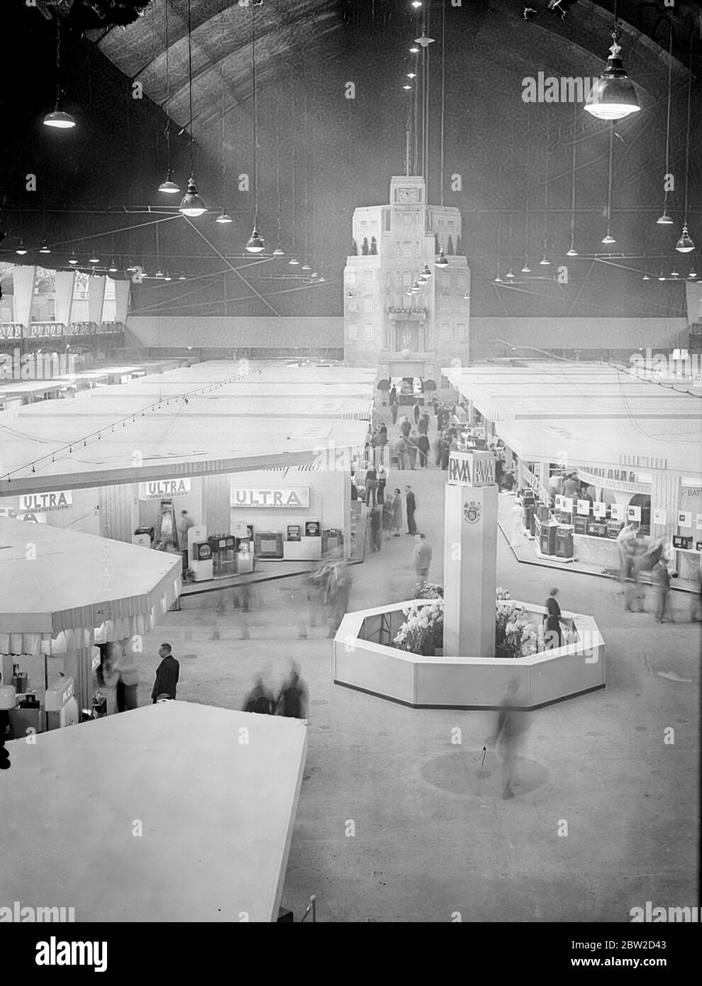 Radiolympia, Britain's biggest ever radio show, was opened at Olympia, London, for the first time by television. The first opening speech ever made to a public exhibition by television was delivered by Sir Stephen Tallents, BBC Public Relations chief, from Alexandra Palace. A general view of the show with a representation of Broadcasting House in background. 22 August 1939 Stock Photo