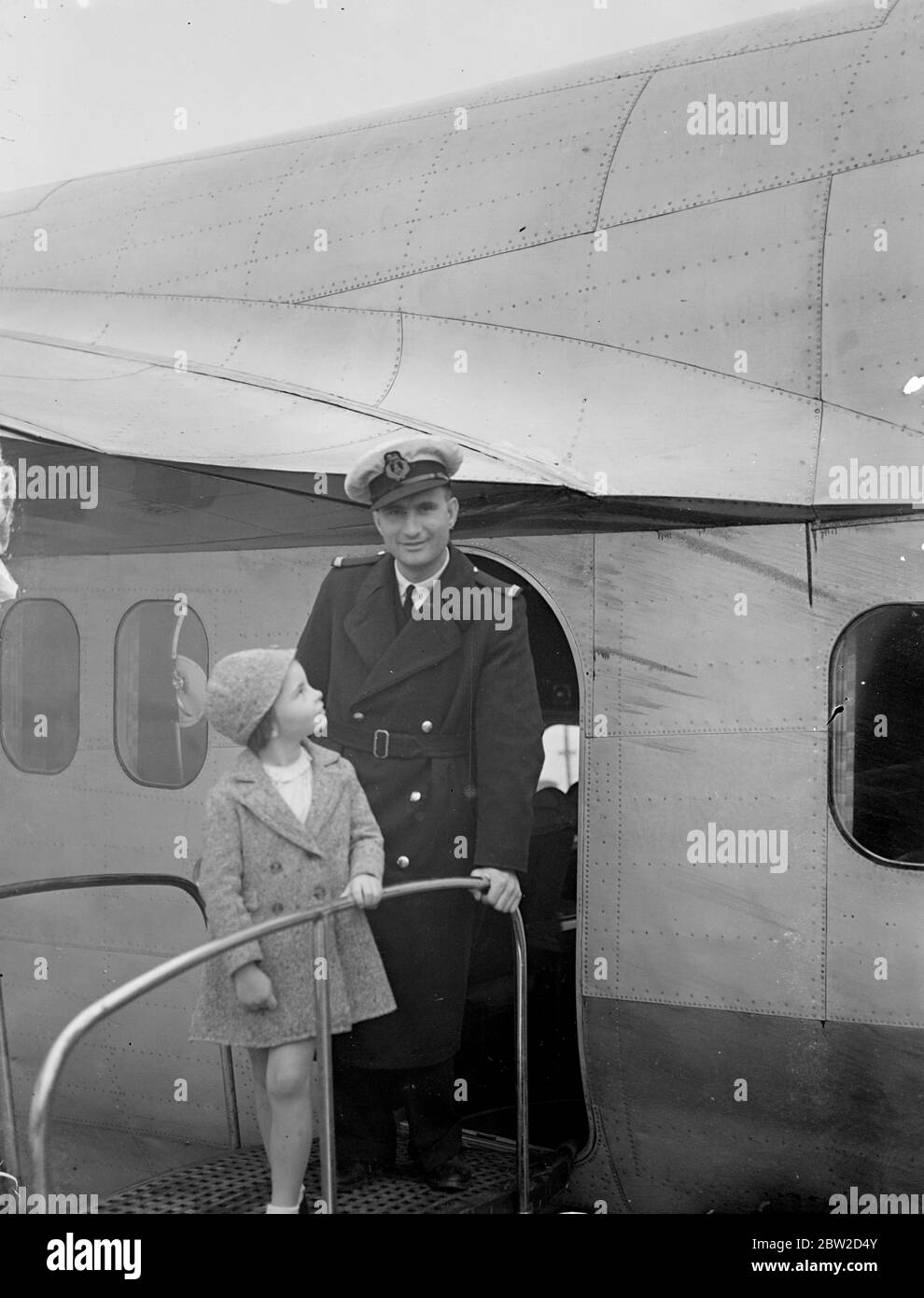 Sylvia Heyder who is only 7 1/2 years old arrived at Southampton in the Imperial Airways flying - boat Carpentaria from Lorenco Marques, Portuguese East Africa, to stay with her grandmother in Liverpool. Sylvia was accompanied by her parents. Photo shows Sylvia Heyder leaving the flying boat at Southampton. 23 June 1939 Stock Photo