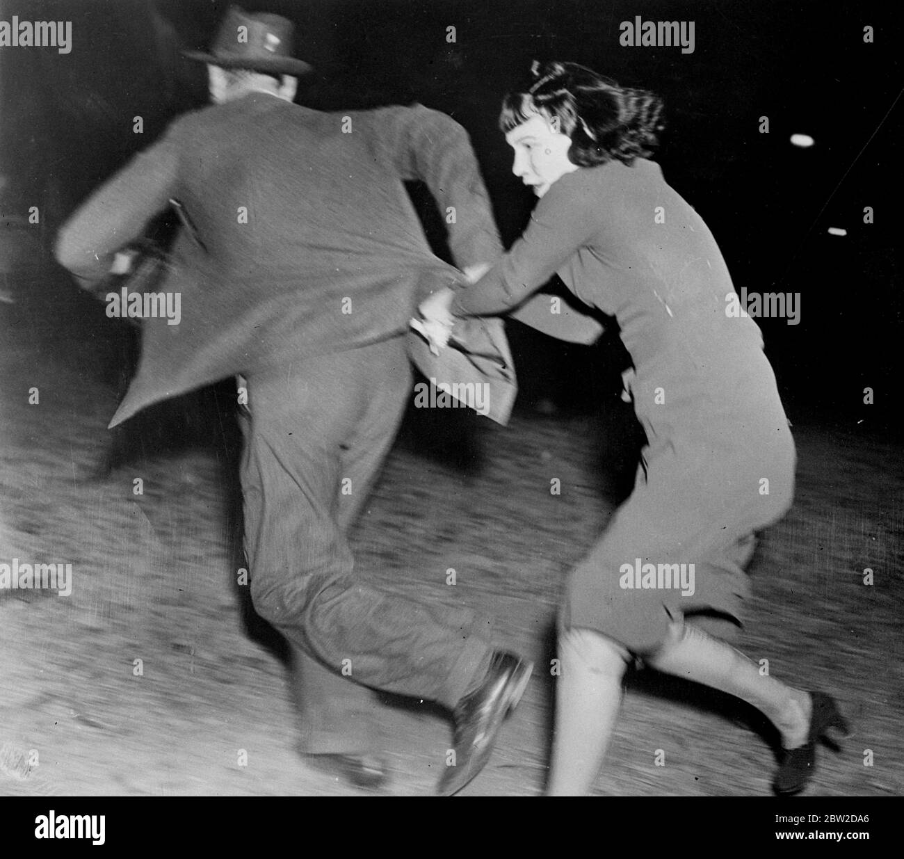 In a battle royale in front of the palatial home in Wiltshire Boulevard, Los Angeles, Mrs Anna Laura Barnett, white widow of Jackson Barnett, world's richest Indian [Native American], and her daughter routed the United States Marshall, who attempts to serve them an eviction order, and photographers.The women hurled numerous objects and the daughter came to grips with several other photographers. Mrs Barnett married the aged Creek Indian 13 years ago after oil was struck beneath his shack in Oklahoma. Later the courts ruled that marriage was invalid. Photo shows: Mrs Maxine Sturgis, the daughte Stock Photo