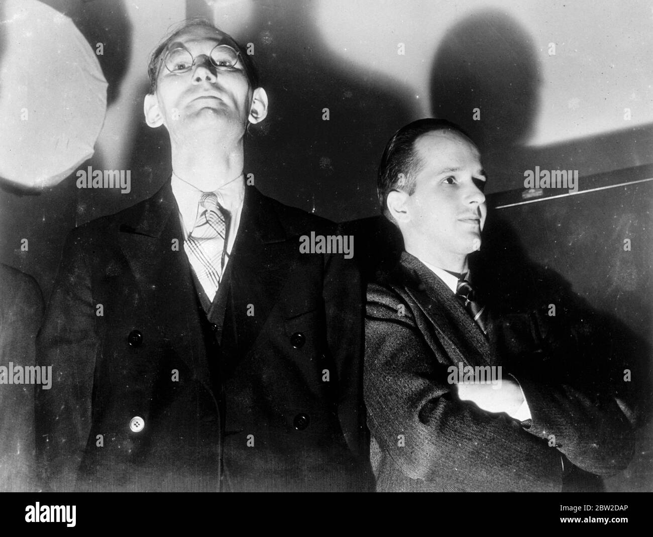 Otto Hermann Voss, left, and Gunther Gustav Rumrich as the two men entered the federal court in New York to answer charges of being implicated in a great spy ring working on behalf of Germany in the US. As the trial started, Rumrich stepped forward and pleaded guilty to espionage charges. He became State's evidence and told astonishing story about the activities of the alleged spies in the United States. 24 October 1938 Stock Photo