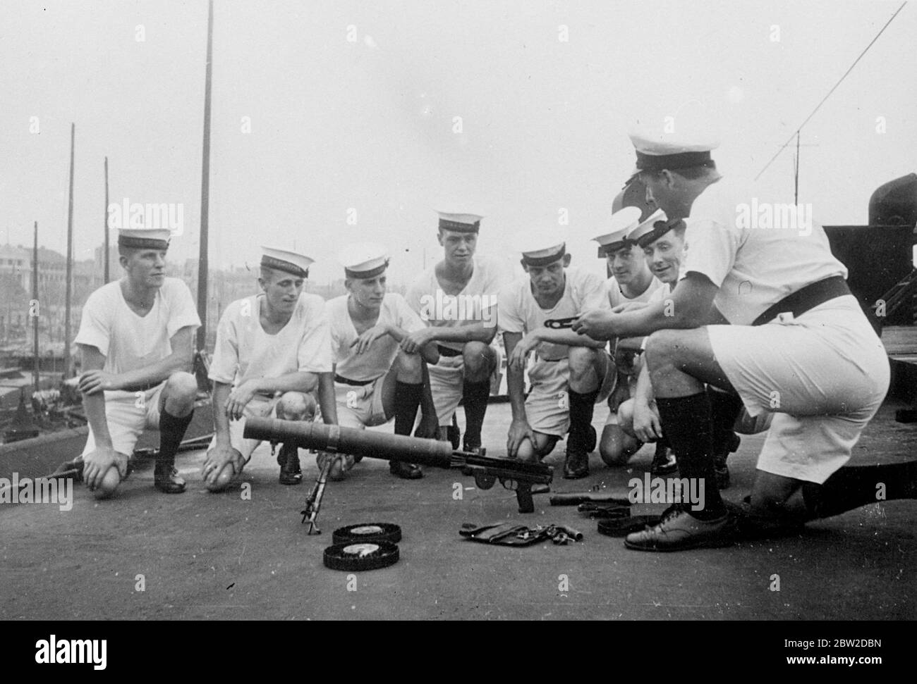 With the Japanese pressing nearer to Hancow, the provisional Chinese headquarters, 108 officers and men of the Royal Navy have been sent especially to protect British lives and property. Members of the contingent are quartered on Yangtze River steamers. Photo shows: Machine gun instruction for British naval ratings at Hankow. The Bund is seen in the background 21 October 1938 Stock Photo