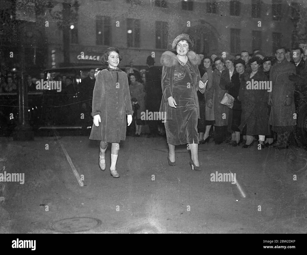 Queen takes Princess Elizabeth to 'Where the Rainbow Ends'. The Queen to Princess Elizabeth to see the patriotic Christmas play 'Where the Rainbow Ends' at Holborn Empire. Photo shows, the Queen, arriving with Princess Elizabeth at the Holborn Empire. 21 December 1937 Stock Photo