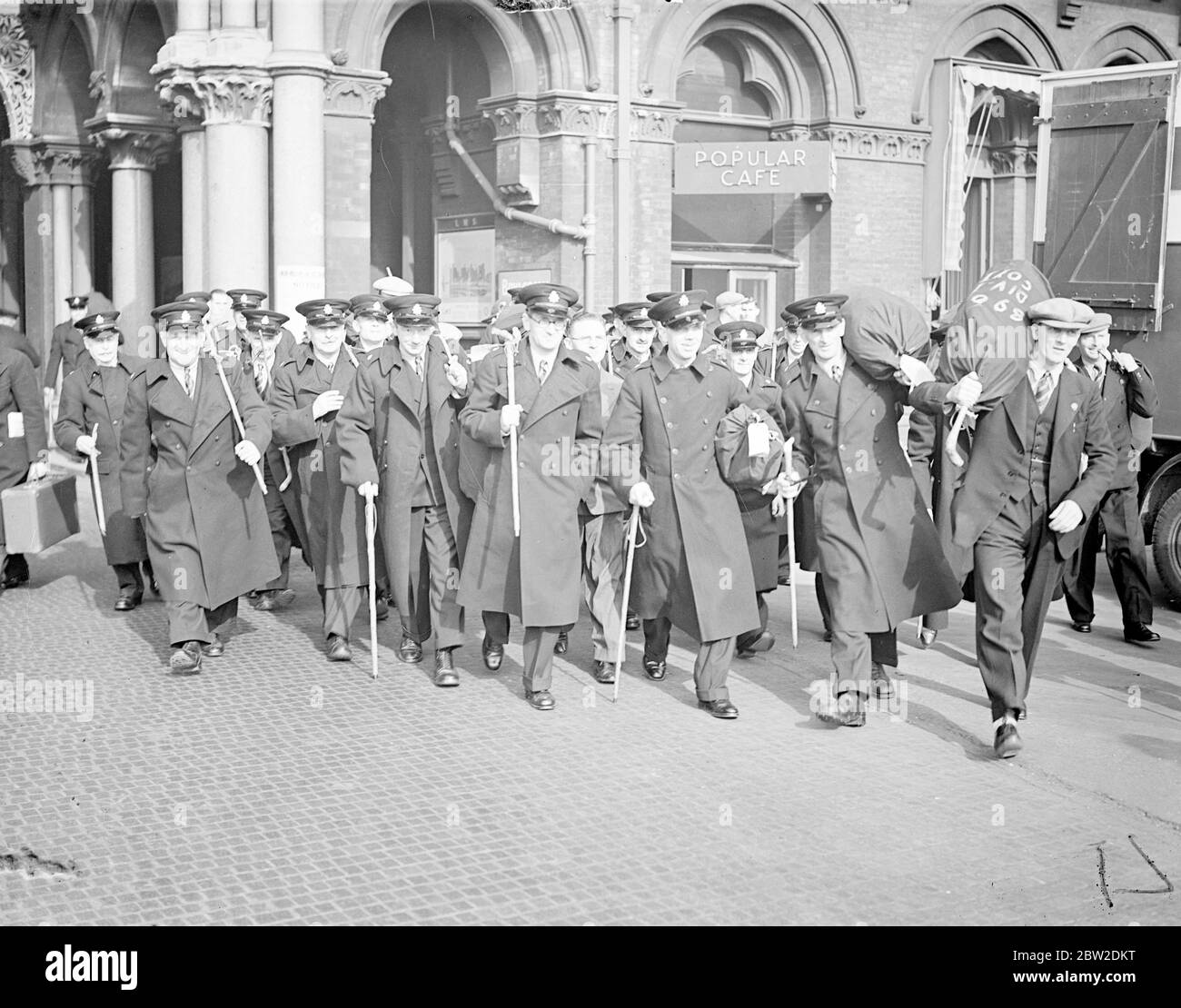 The British Legion police force, which has been waiting in two ships in the Thames estuary ready to go to Czechoslovakia for plebiscite duty, arrived at St Pancras station from Tilbury in special trains on the way to their homes. The force of 1200 men is being disbanded following the decision of the International Commission in Berlin that plebiscite will not be necessary. Photo shows: Plebiscite police marching away from St Pancras station. 15 October 1938 Stock Photo