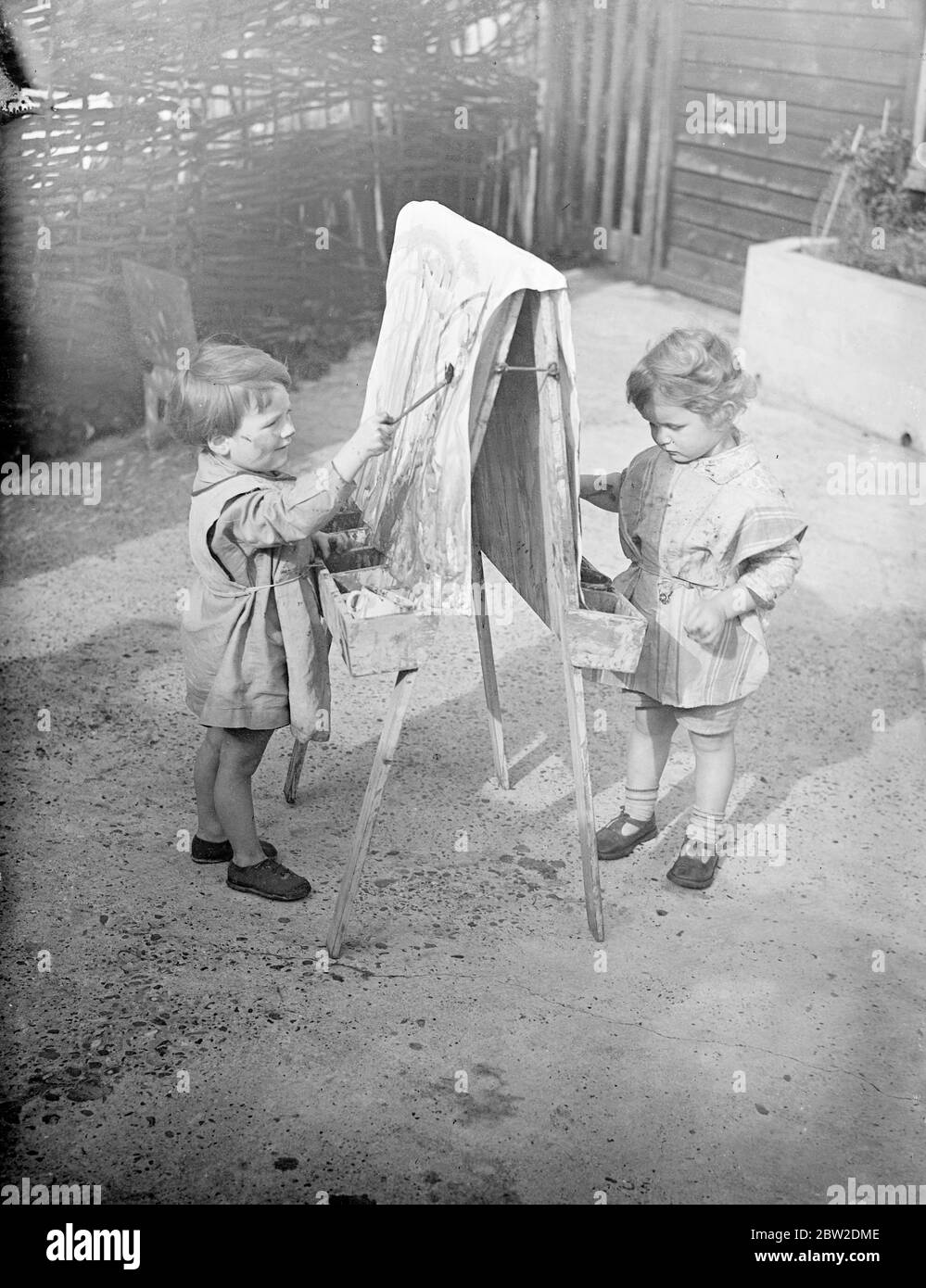 50 tiny children under five years of age at the Romani nursery school provided first-hand specimens for the students of the Gypsy Hill Training College for Teachers of Young Children, Gypsy Hill, to which it is attached. The college was the first in Britain to undertake the training of teachers for nursery schools. Children at the nursery school can bathe a baby, use correct table manners and cook. They are to give a display before the Duchess of Kent in the city on November 10 to help raise money for the college. Photo shows: Tiny pupils of the nursery school trying their artistic skill. 14 O Stock Photo