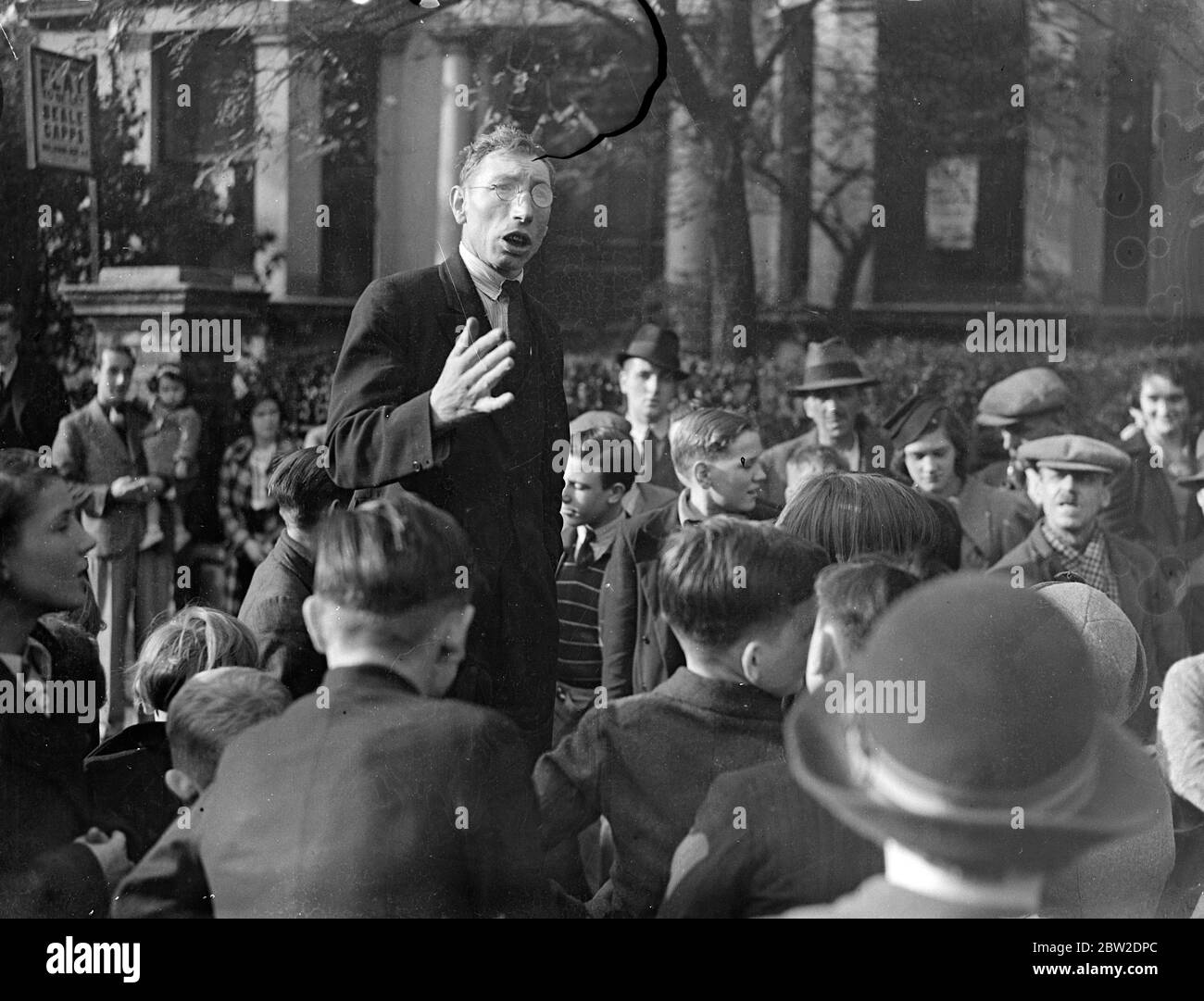 As a protest against the increasing number of road accidents involving children of the district, residents attended a meeting in Cambridge Gardens North Kensington, London organised by the North Kensington pedestrian protection committee. Mr Sidney Jones organiser of the committee making his speech. 10 October 1937. Stock Photo
