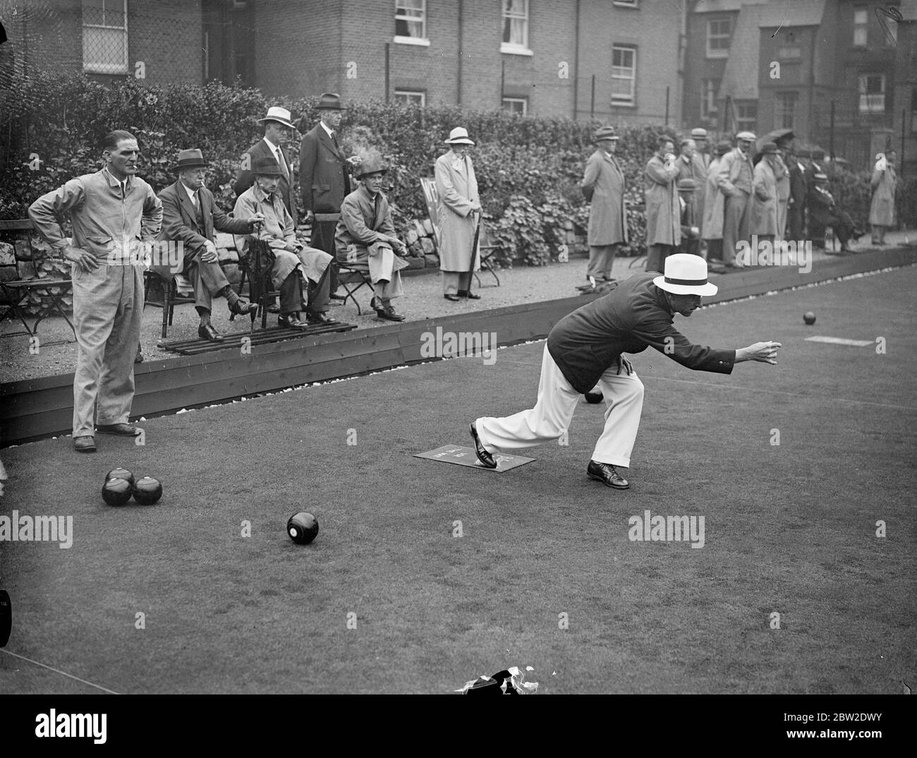 In heavy rain 18 players out of nearly 5000 from all parts of Britain competed in the finals of the National single Bowls championship at Paddington Bowls club, London. I. Crankshaw of the Cheltenham Bowls Club in play at Paddington. 14 August 1937. Stock Photo