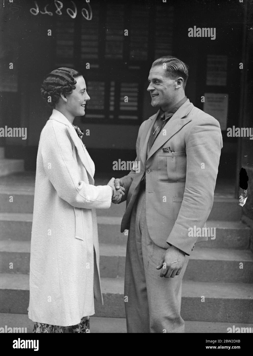 Ronald Walker receives good luck wishes from an admirer at Faringdon Hall. He is the strongest man at his weight in the world and is attempting to break to records his own world record for two-handed snatch the world record for two hands clean and jerk, at the Olympic weightlifting championships, London. 24 July 1937 Stock Photo