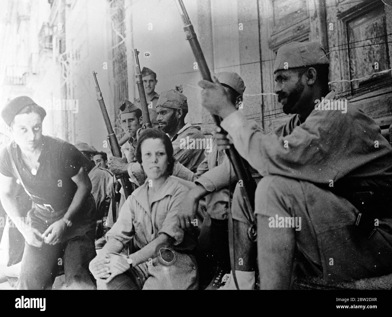 17 year old Anita Royo from Morocco with Moorish soldiers on the Madrid front. She ran away from home in Melilla and stowed away secretly to southern Spain, she is the only woman serving with the rebel forces on the Madrid front and acts as a nurse. 13 August 1937 Stock Photo