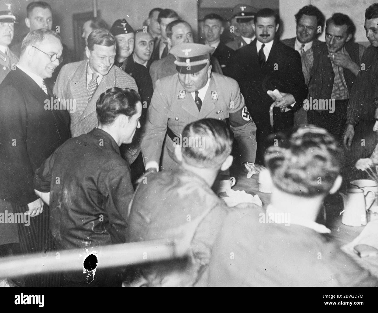 Making his first visit to the city in 13 years the Duke of Windsor was welcomed by the workers when he made his preliminary inspection of factories in by them, as quoted by German officials. The Duchess may man arrested at hotel the Duke of Windsor is to study housing and factory conditions and Germany before going to America on a similar mission. 11 October 1937. Stock Photo