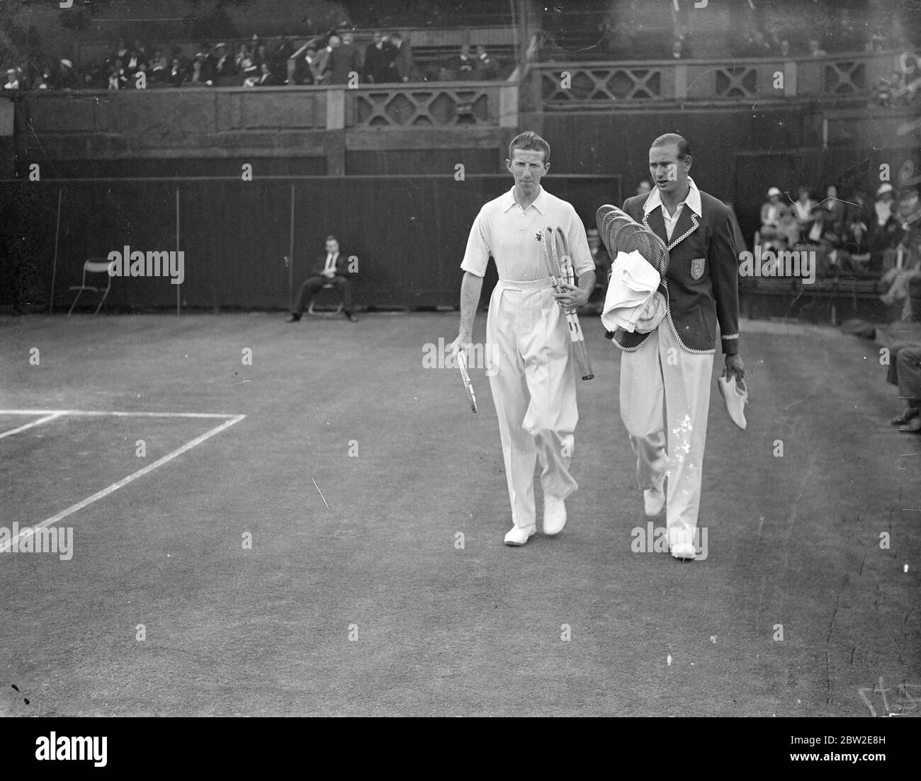 CE Hare of Great Britain and Donald Budge, making their way onto court. Hare beat Budge to become Wimbledon champion winning 13-15 in their singles match in the Davis cup challenge round at Wimbledon. 24 July 1937 Stock Photo
