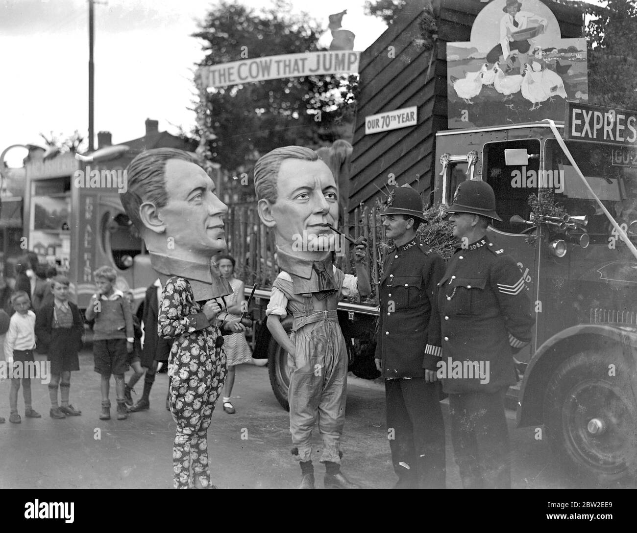 Eltham Carnival in Kent. Policemen talking with the Big Heads. 1934 Stock Photo