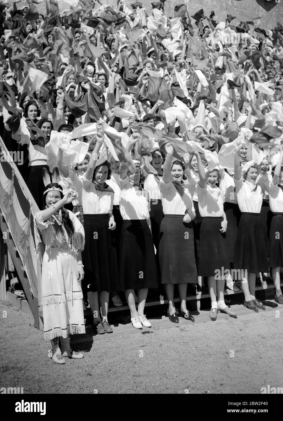 King George VI and Queen Elizabeth ontheir Canadian tour of 1939 . The King and Queen's welcome at Saskatoon, Saskatchewan by Indian girl students Ninaki , a chief woman of the Blackfeet Indians among the crowds. Stock Photo