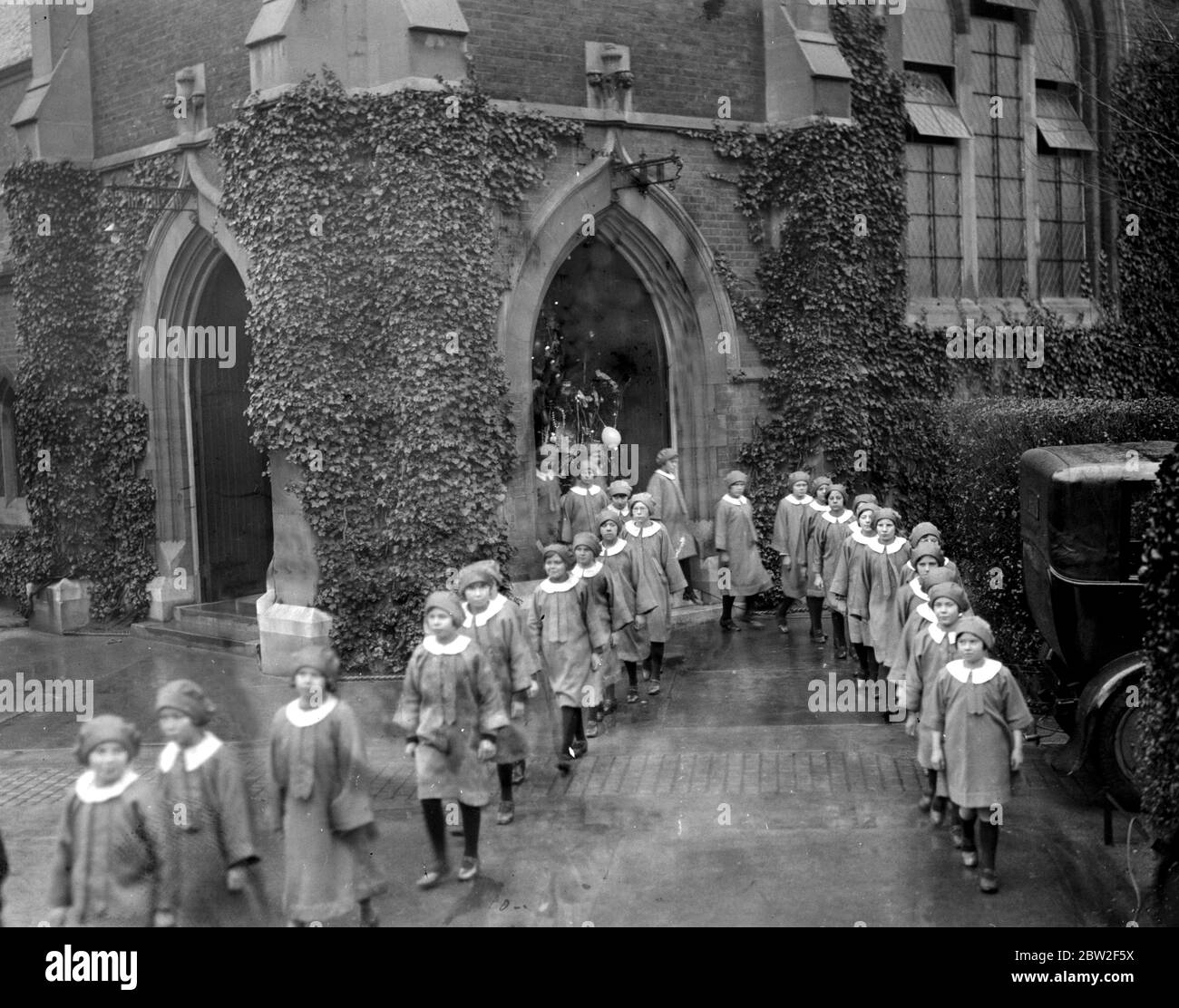 The girls choir of the Barnardo Village Homes at Barkingside after practising Christmas Carols. 15 December 1934 Stock Photo