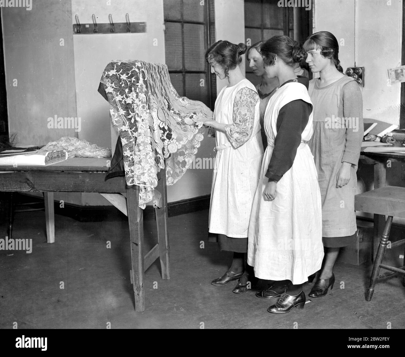 Lace making at messrs William Bridgett and Sons Ltd, Lenton, Nottingham. Work girls inspecting the finished lace. 1923 Stock Photo