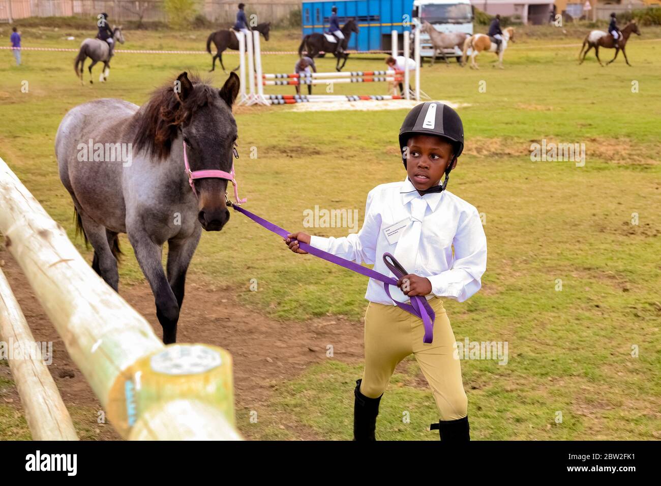 Soweto, South Africa April 16, 2012 Young African horse riding kids