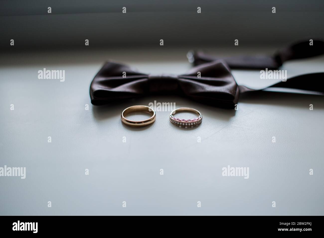 Close Up Of Modern Man Accessories Wedding Rings Black Bowtie