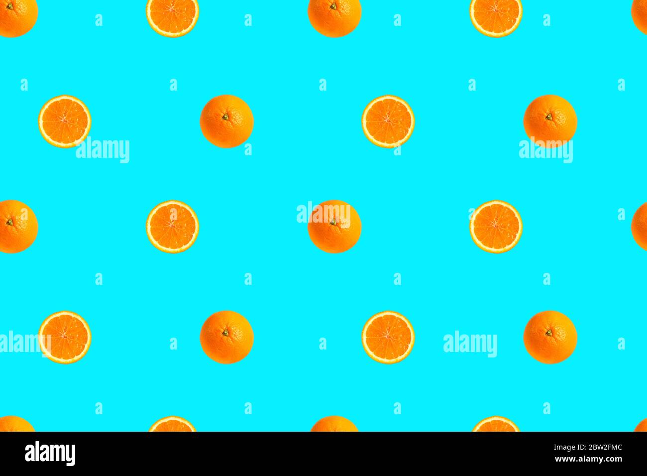 Oranges on bright light blue background seamless pattern. Stock Photo