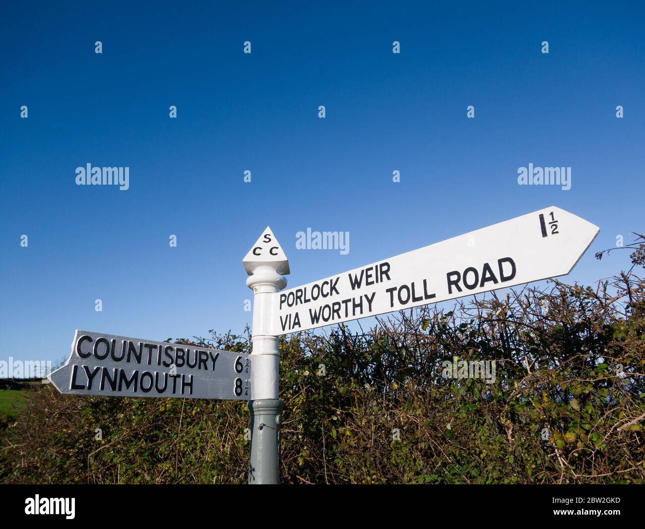 A traditional English cast iron finger rural road sign in Yearnor Mill Lane in the Exmoor National Park, Somerset England. Stock Photo