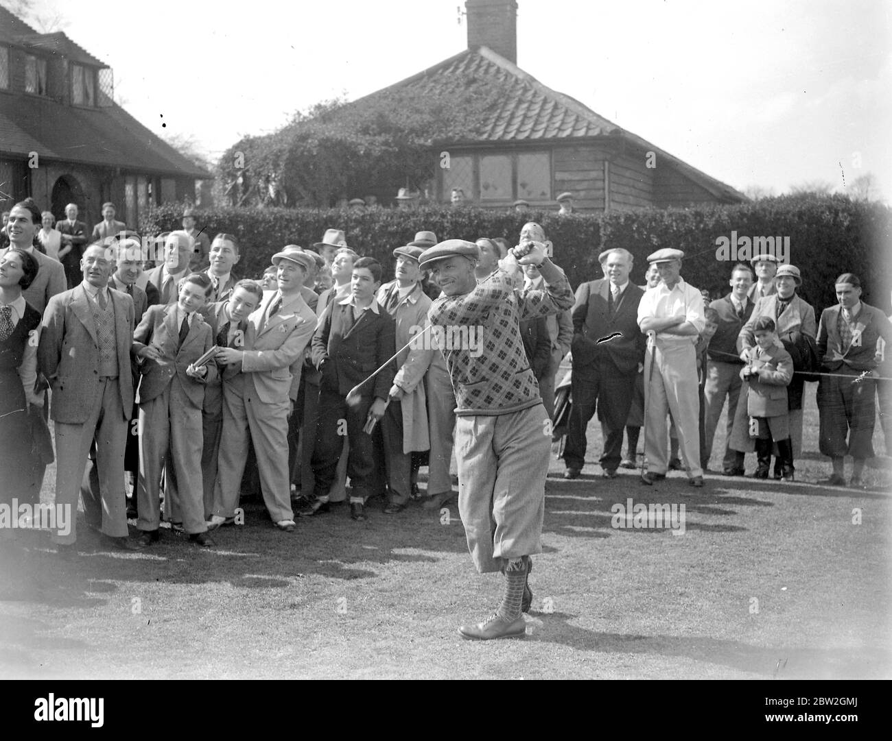 Australian Cricketers. Donald Bradman taking a golf swing. 1934 Stock Photo