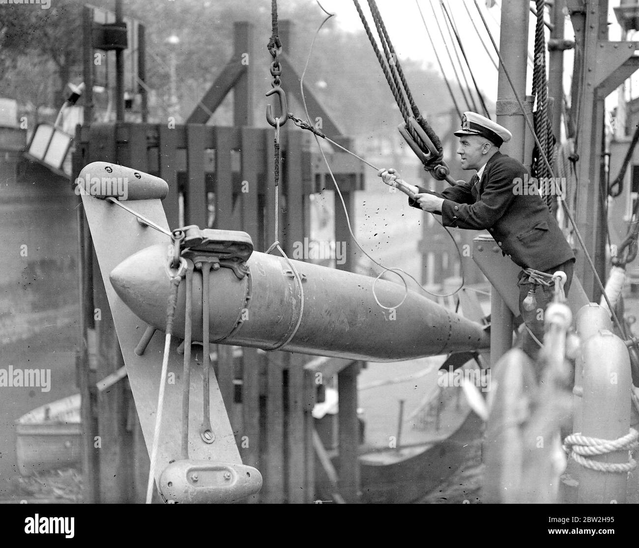 A paravane being affixed to the side of H.M.S. President an item in London's own Navy week. 26 August 1937 Stock Photo