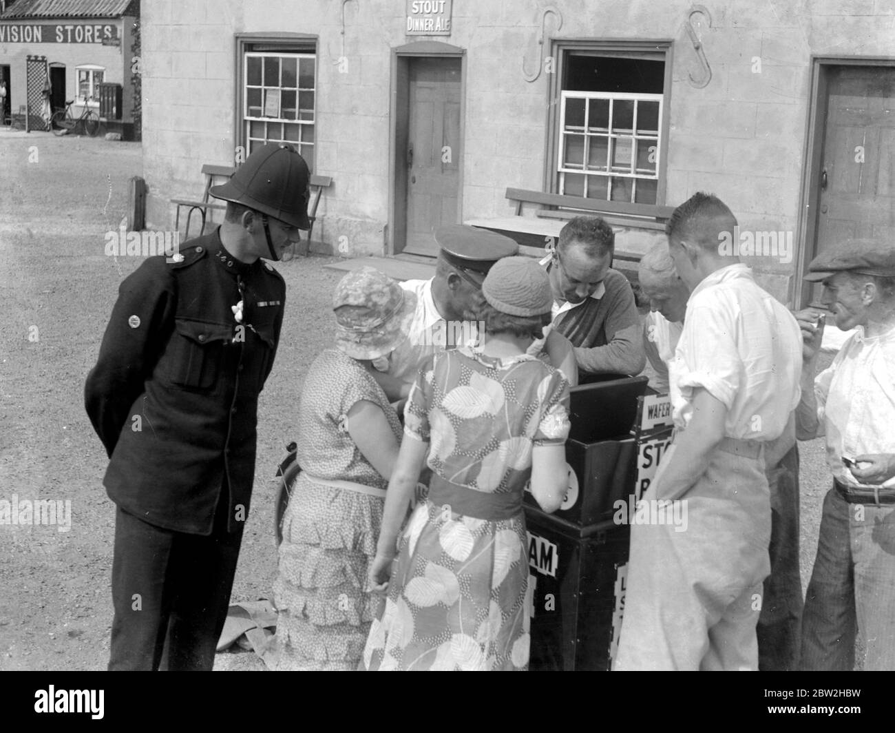 The Norfolk Broads. Summertime and people buying ice cream as a policeman looks on. Stock Photo