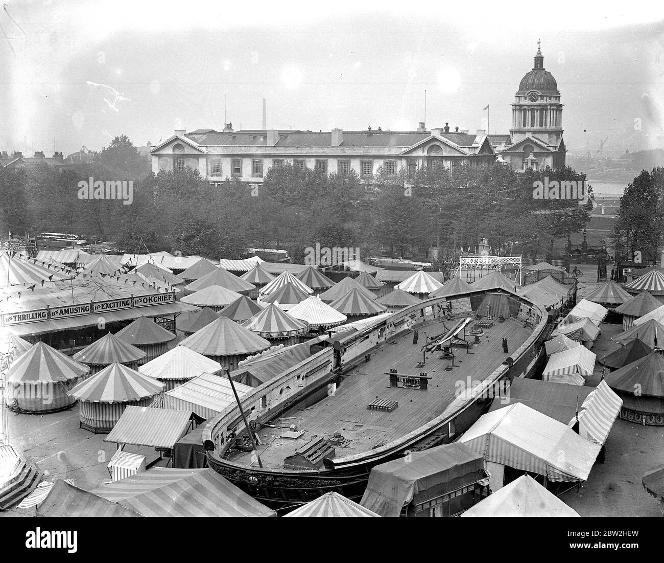 A general view of the fair in the grounds of the Royal Hospital School, Greenwich, London, in aid of the Dreadnought and Miller General Hospitals. The training ship can be seen in the centre, with the Royal Naval College in background. 26 September 1933 Stock Photo