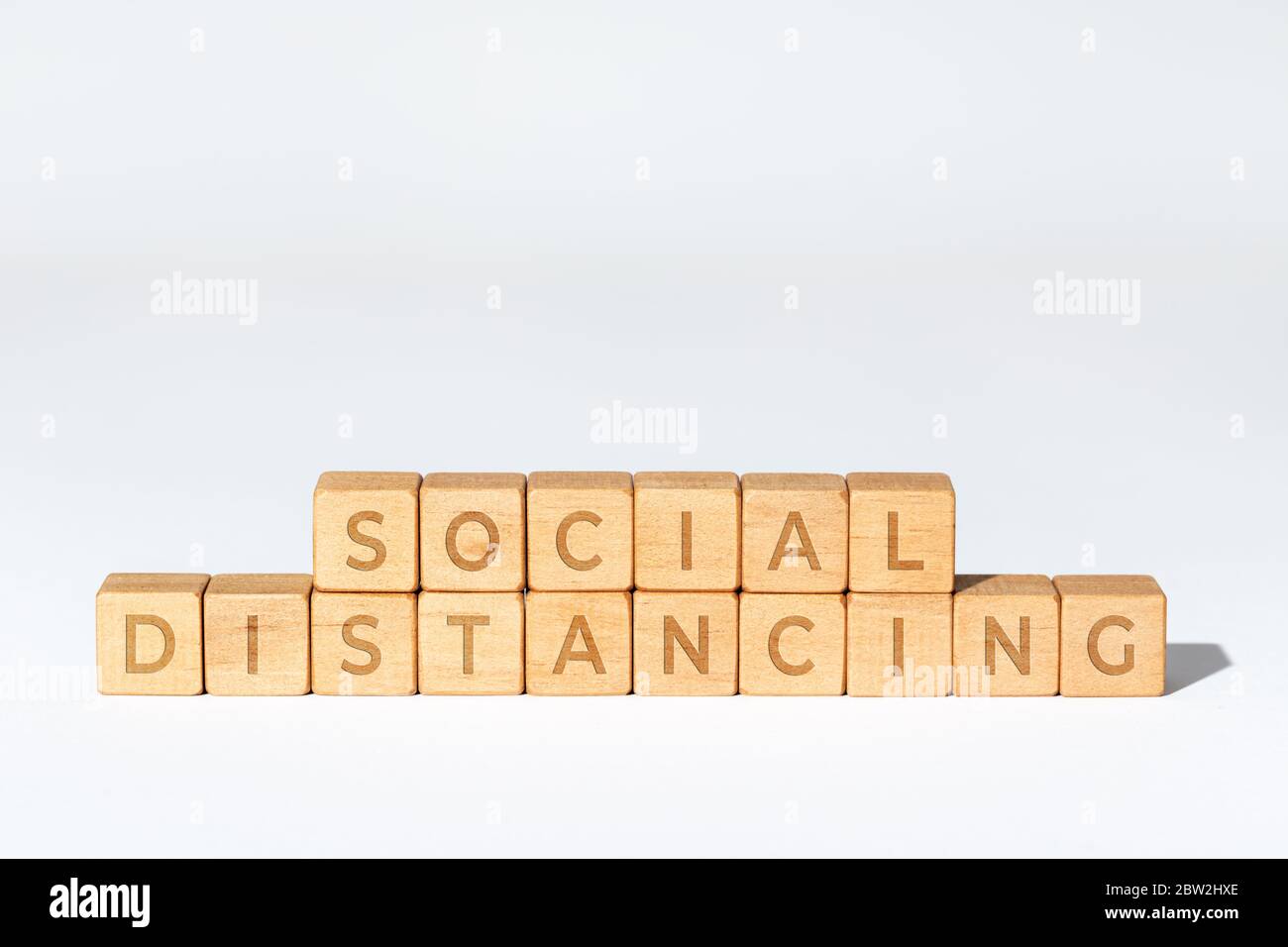 Social distancing concept. Wooden blocks with text. Coronavirus Covid-19 pandemic. White background. Copy space Stock Photo