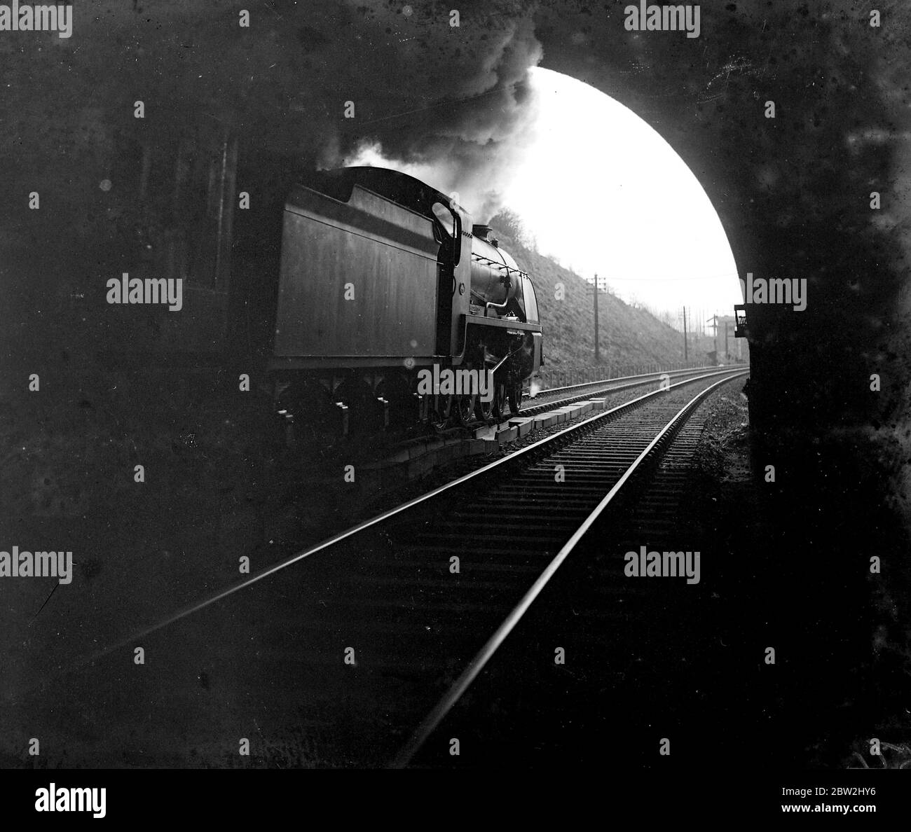 Train leaving tunnel. 1934 Stock Photo - Alamy