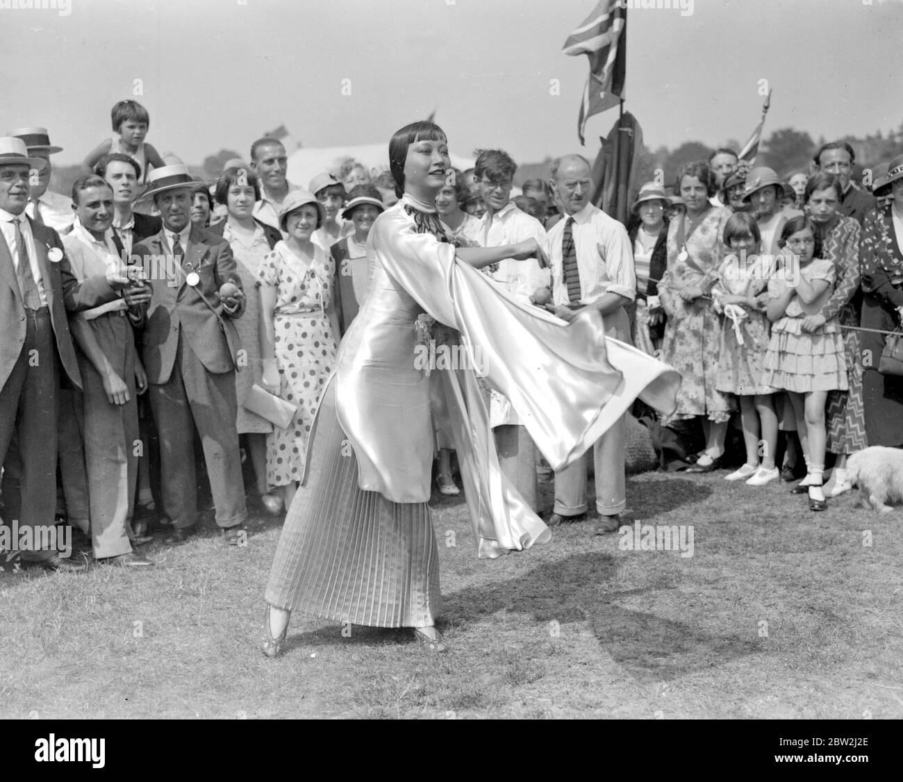 Its a busy day for a cinema star, Anna May Wong, she attended a Hospital Garden Fete at Chiswick, complete with her make-up, dashing straight from the set to fulfill the engagement and immediately had to return to the studio. Picture Shows: Anna May Wong at the fete. undated Stock Photo
